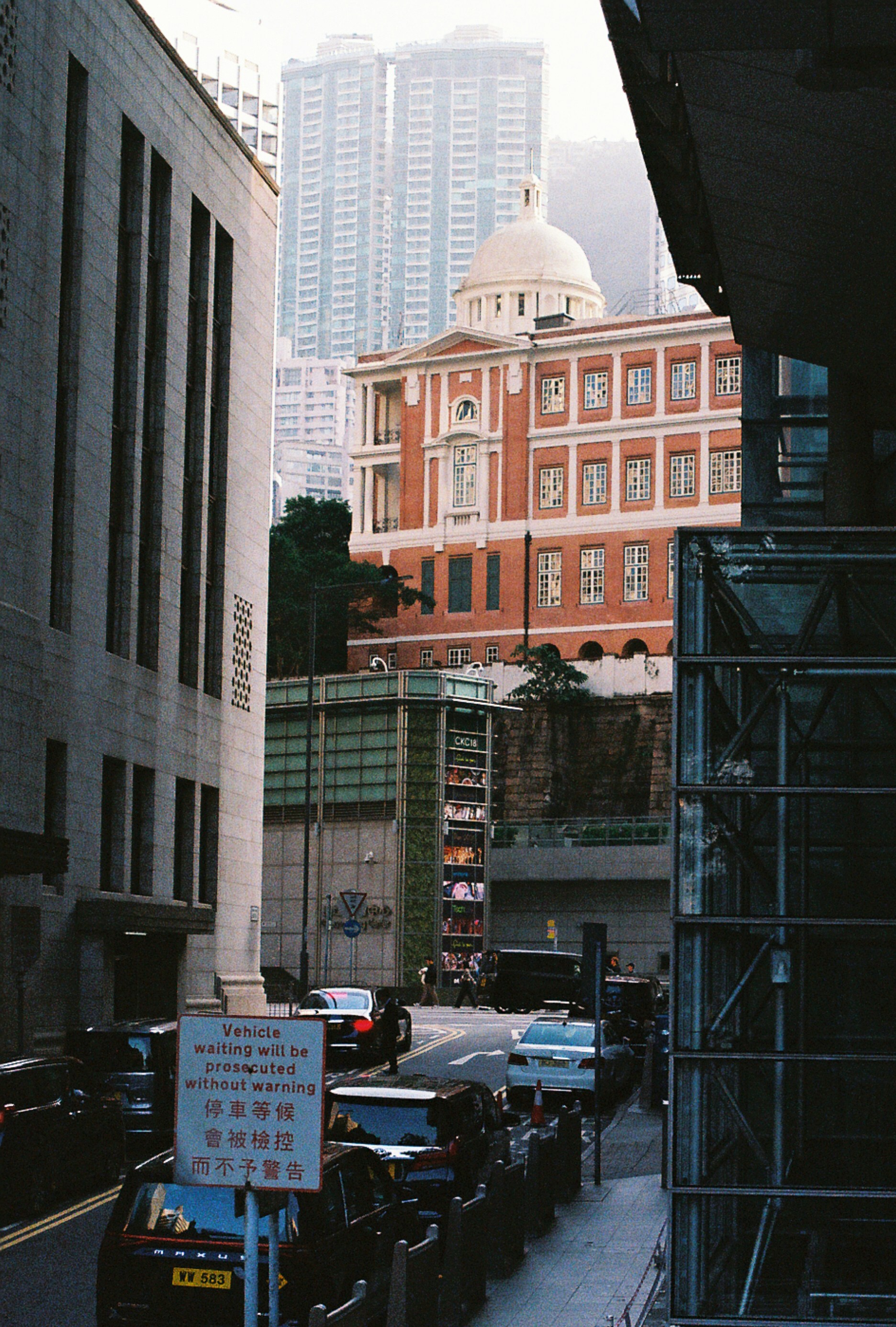 Cityscape features buildings, street and traffic.