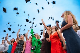 Graduates are throwing their caps into the air.