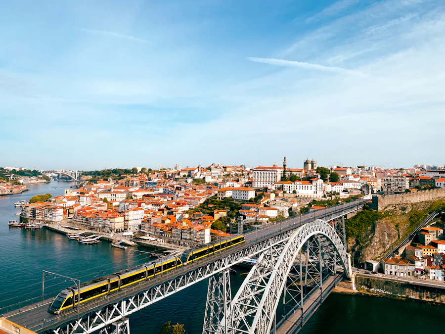 Train crossing Dom Luís I Bridge above the Douro with Porto cityscape beyond
