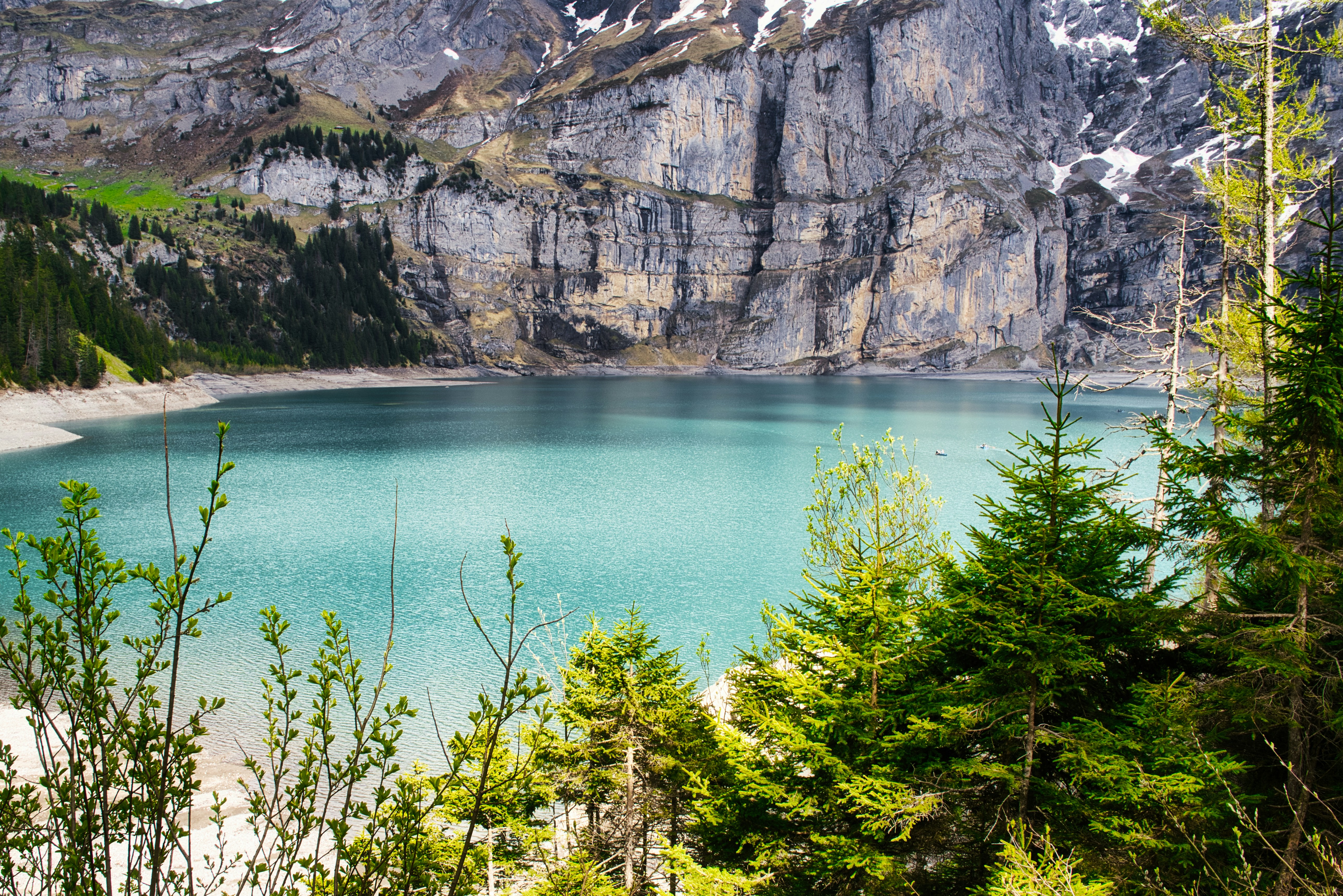 A beautiful lake nestled at the base of a mountain.