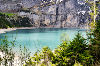 A beautiful lake nestled at the base of a mountain.