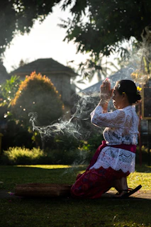 Woman in prayer, with incense smoke.
