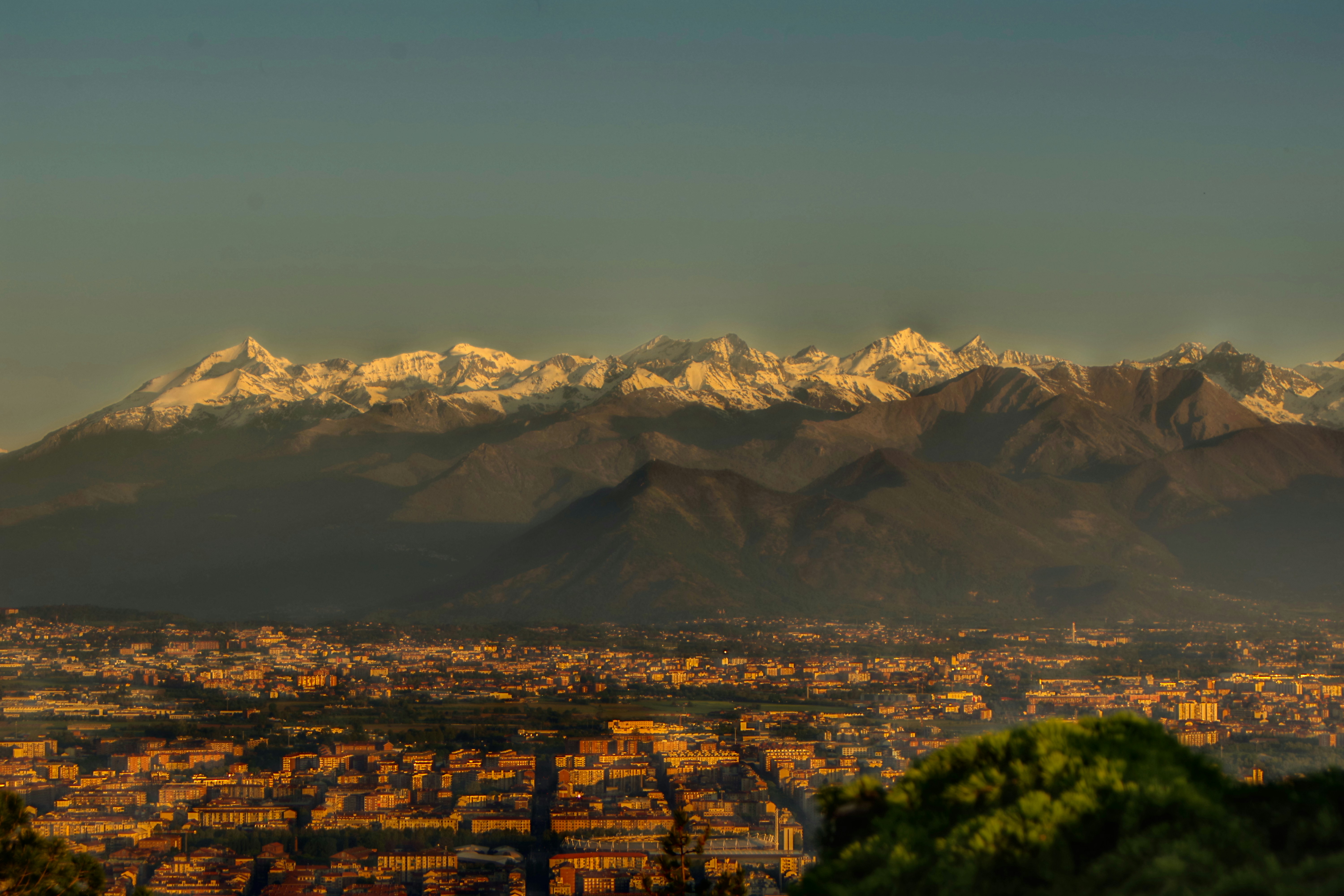 City skyline nestled beneath snow-capped mountains.