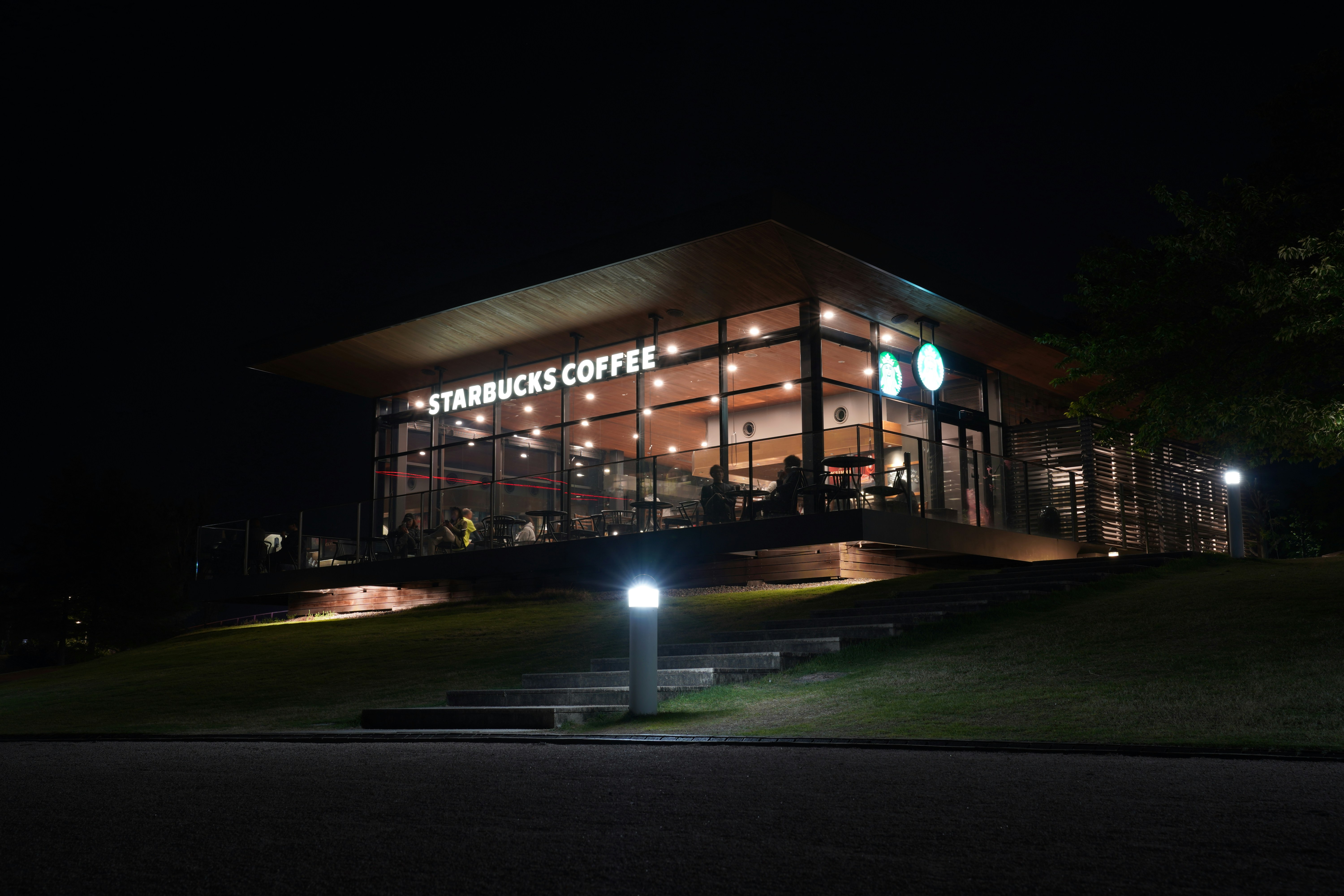 Starbucks coffee shop illuminated at night.