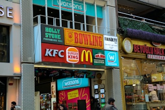 A street with several shop signs and stores.
