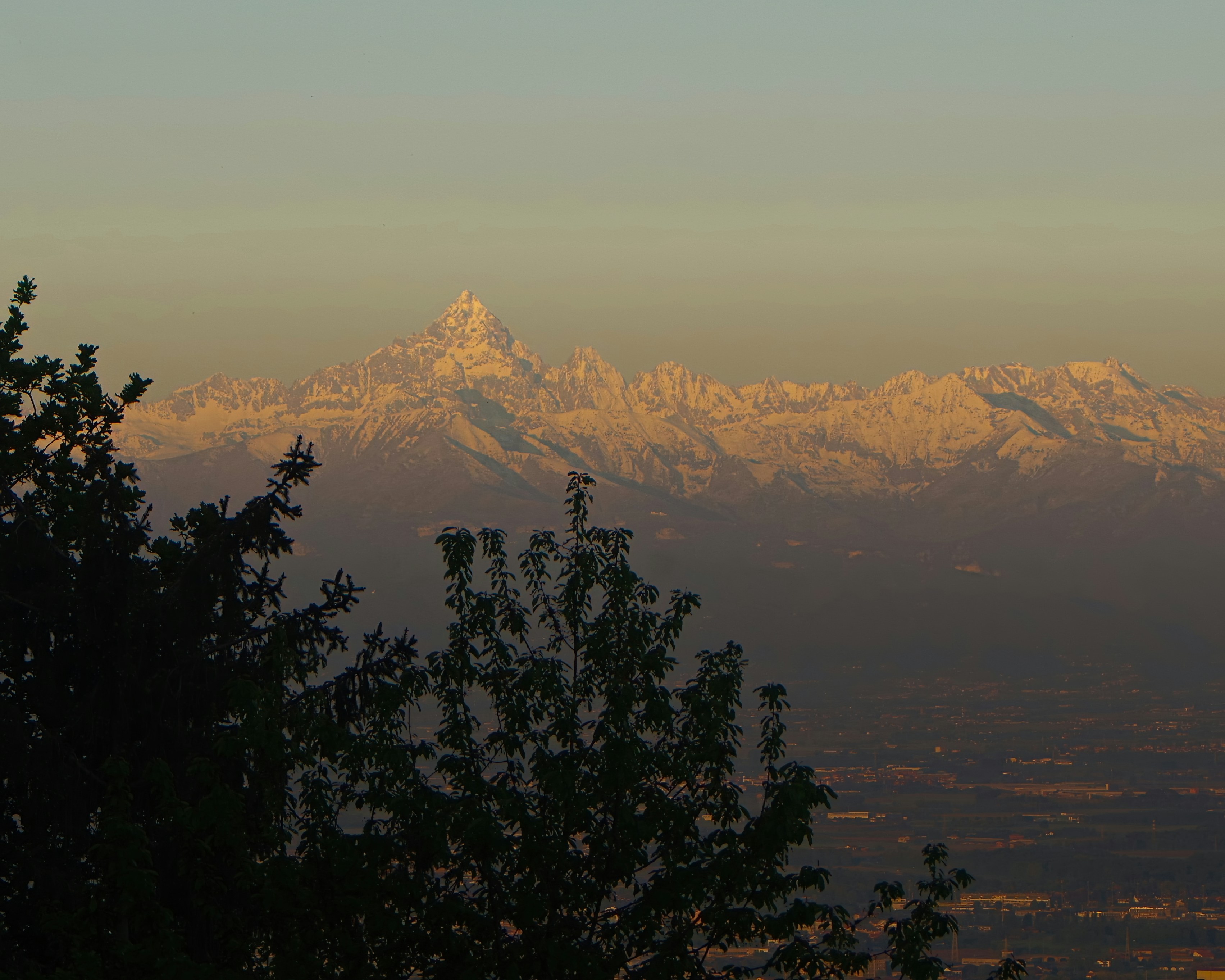 Snow-capped mountains gleam in the morning light.