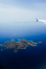 Airplane view of an island surrounded by ocean.