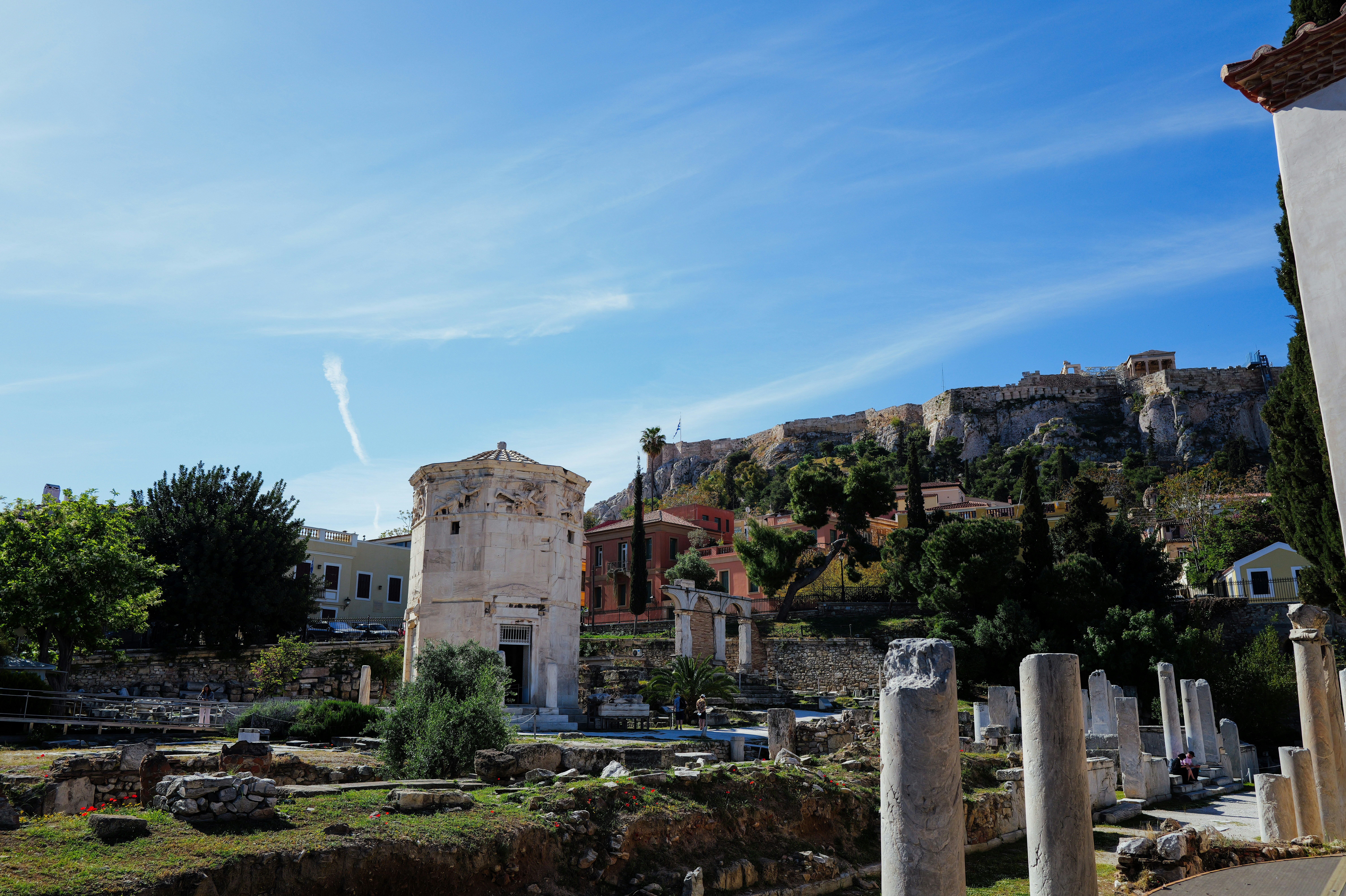 Ancient ruins stand beneath a beautiful blue sky.