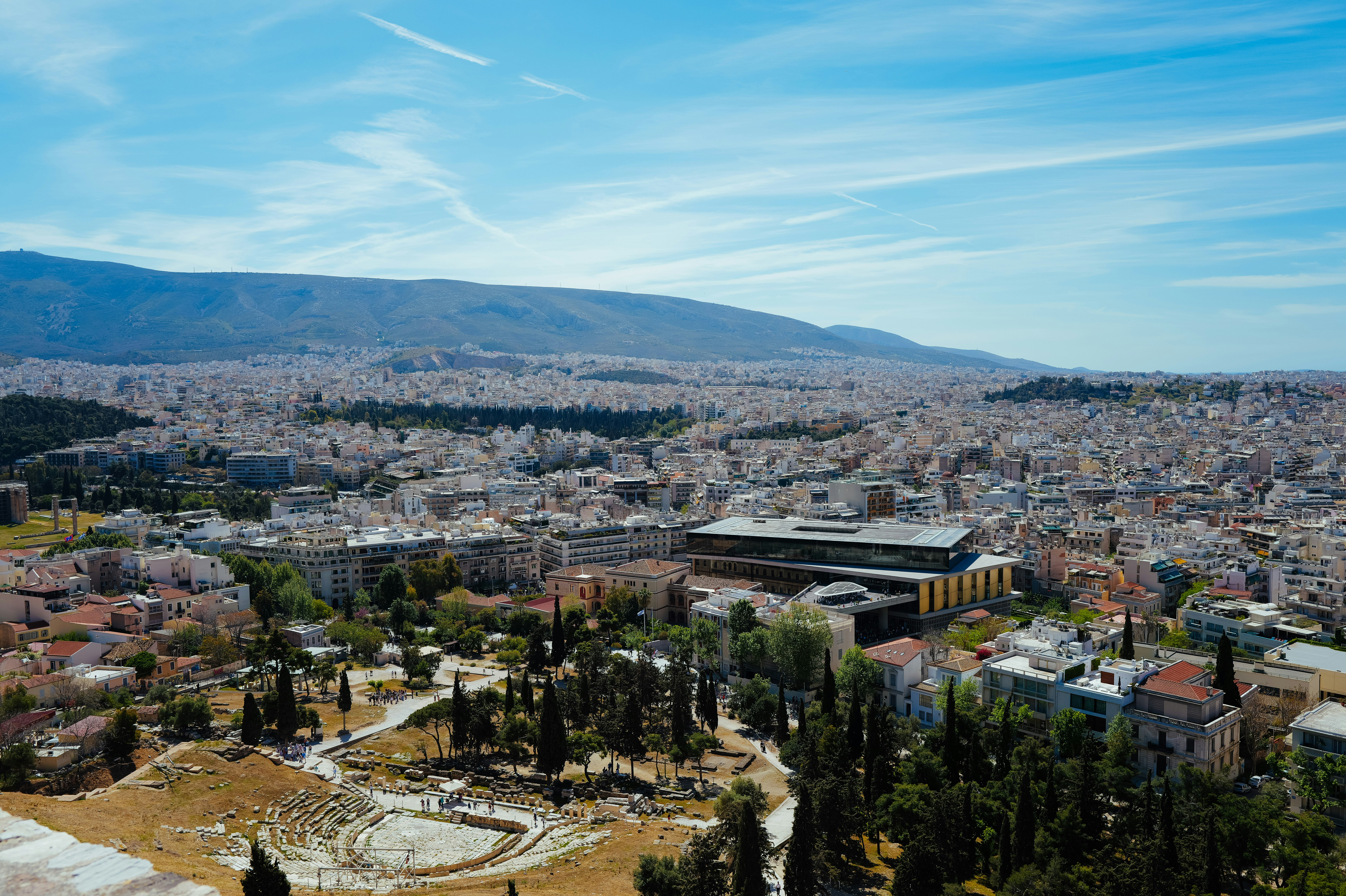 Aerial view of a city with mountains in the background.