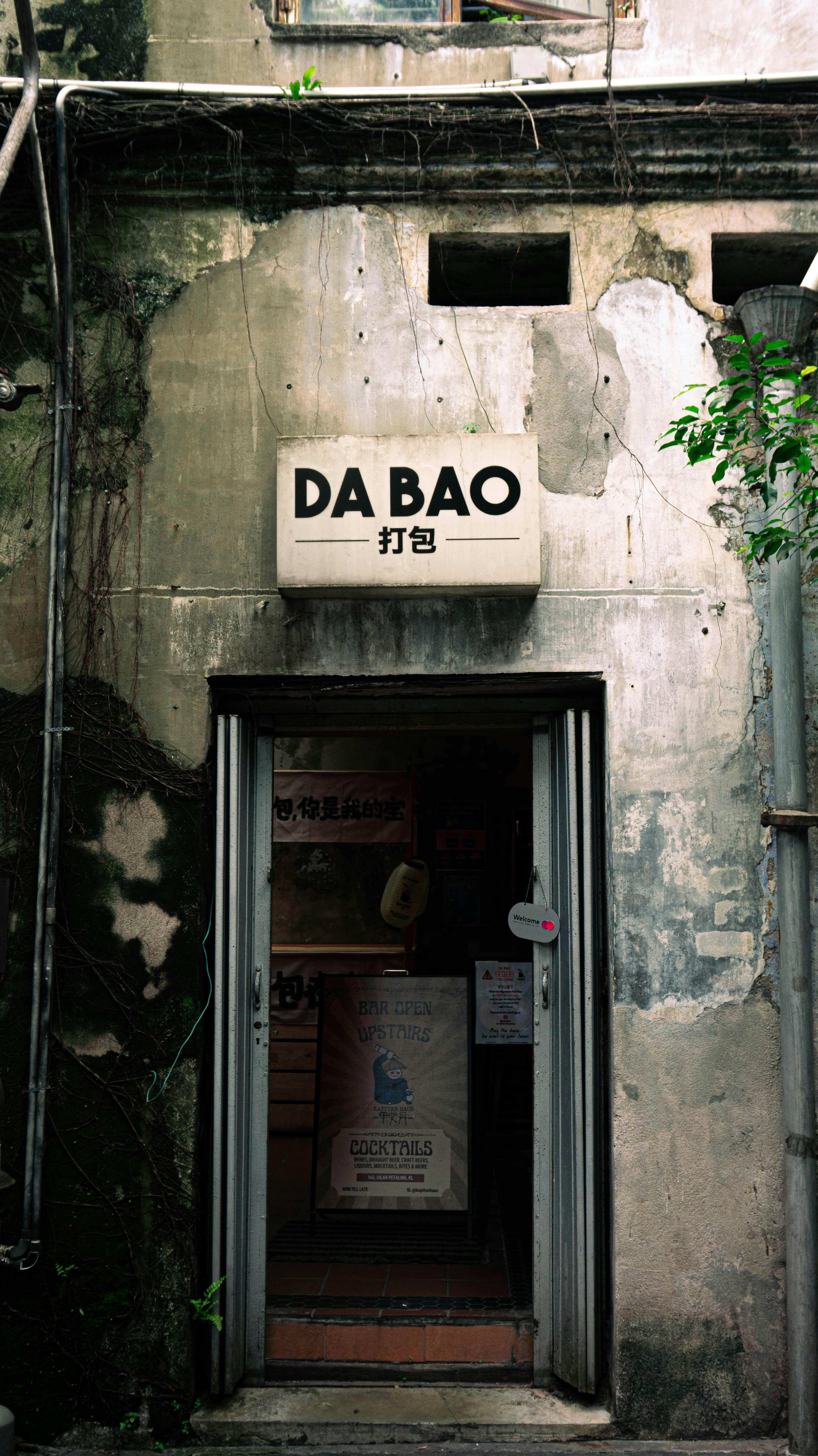 A restaurant entrance with a "da bao" sign.