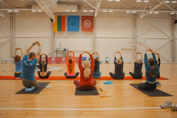 People are stretching during a yoga class.