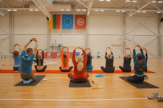 People are stretching during a yoga class.