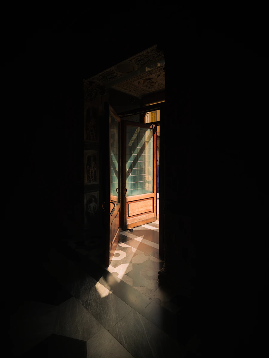 Light streaming through a doorway into darkness