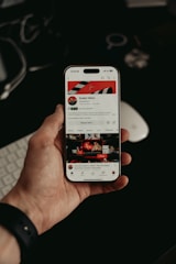 Hand holding phone with YouTube profile — profile picture size guide