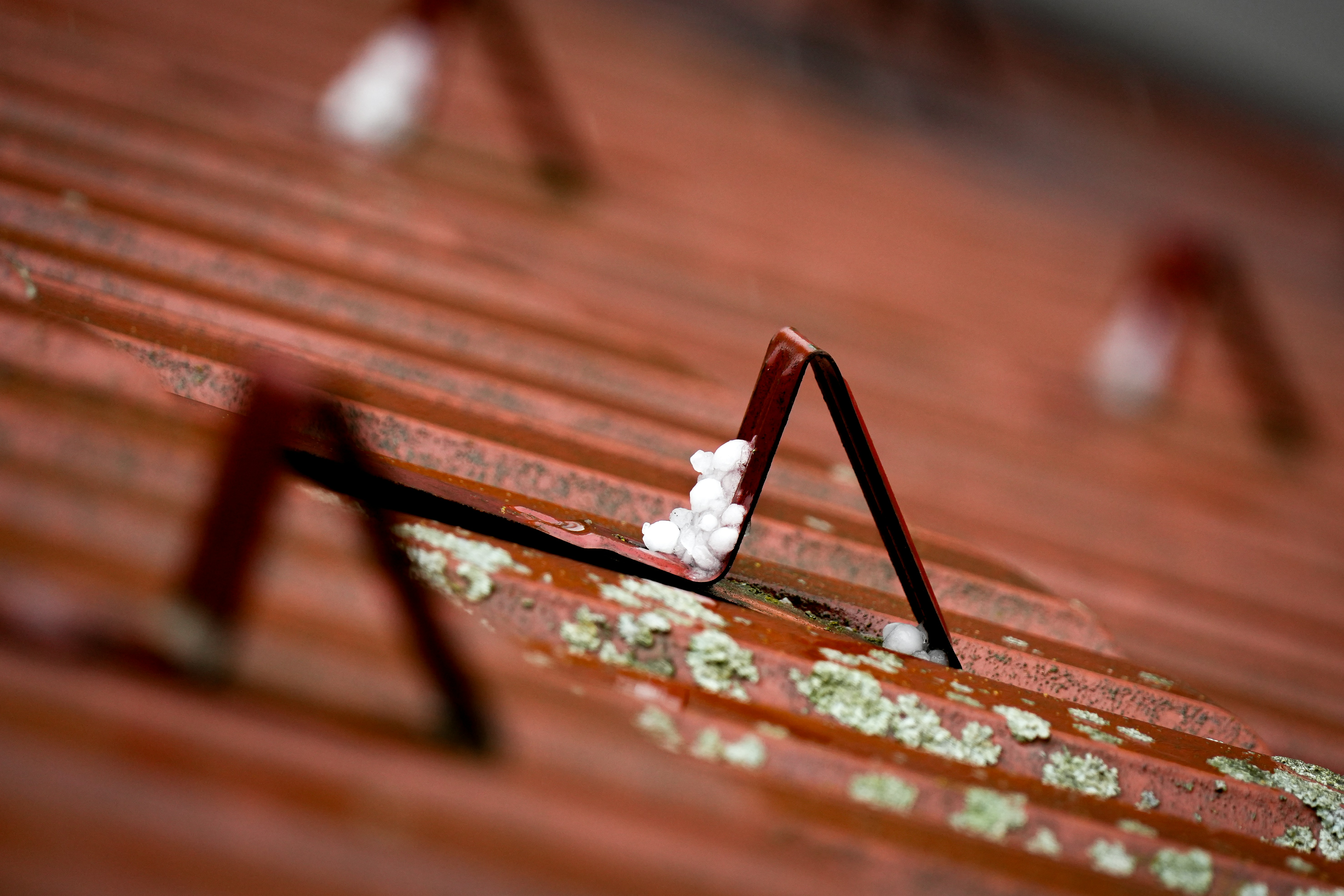 Snowy, weathered roof with metal clamps.