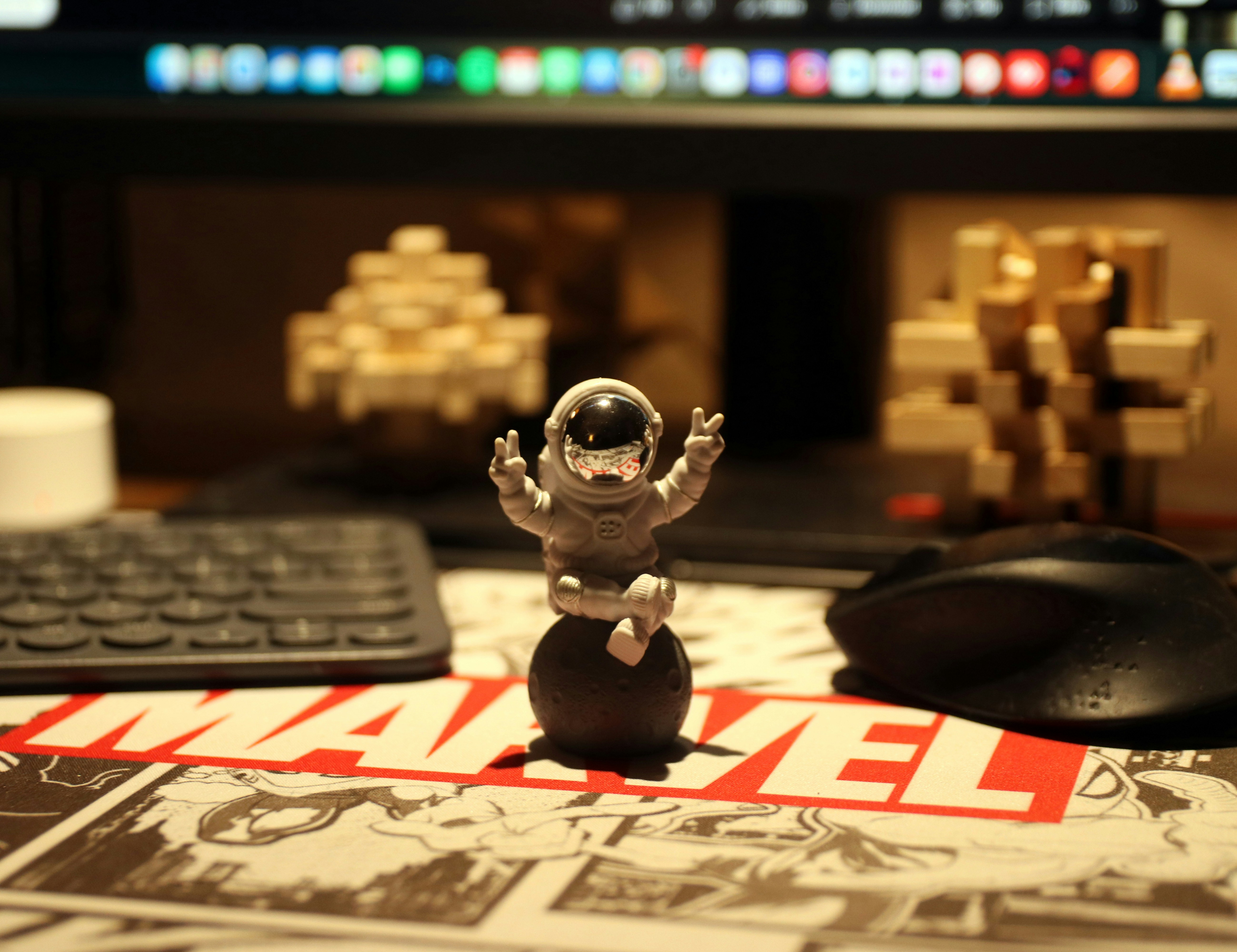 An astronaut figurine sits on a desk.