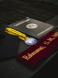 Graduation diploma, medal, and sash displayed.
