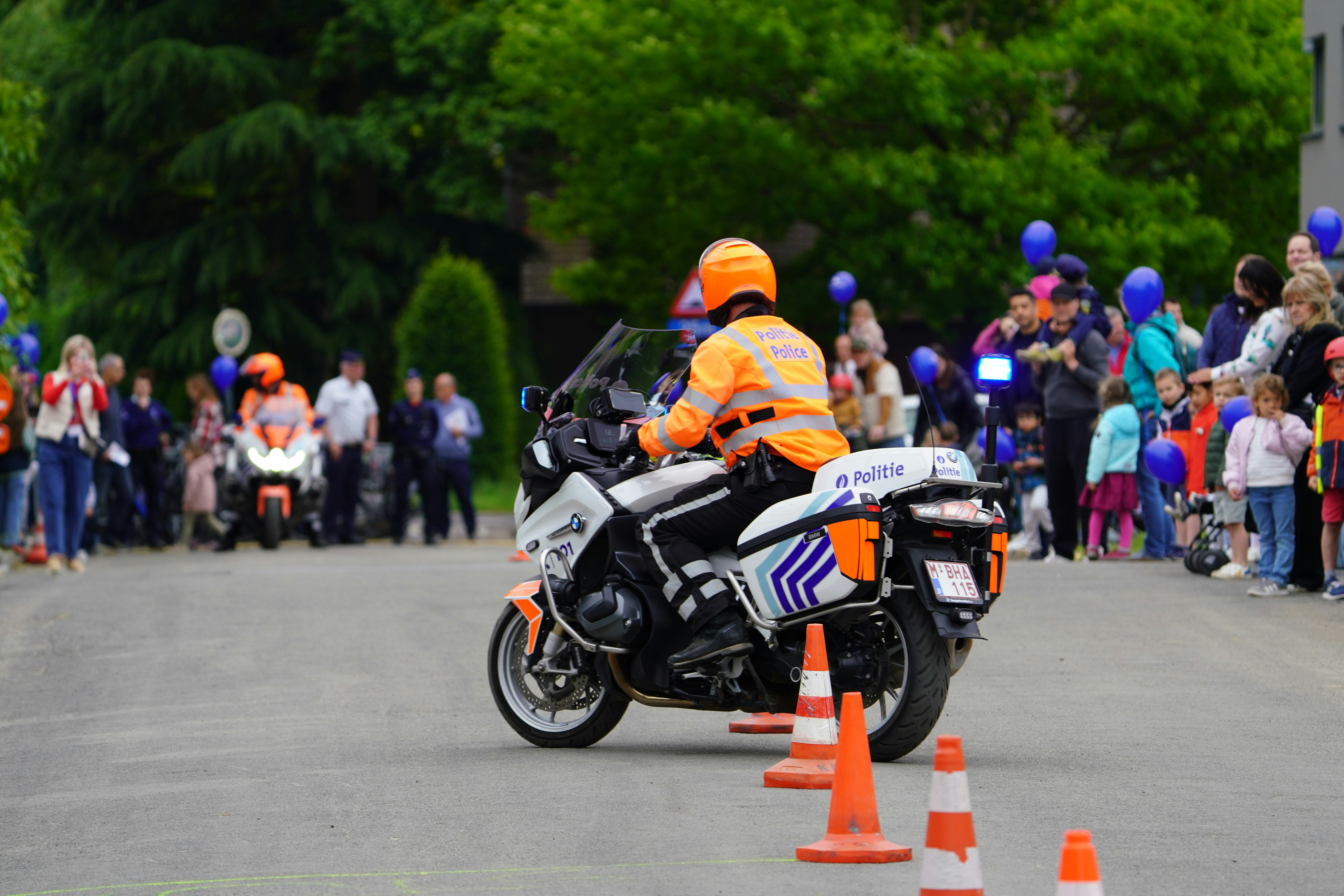 A policeman rides a motorcycle through an obstacle course.