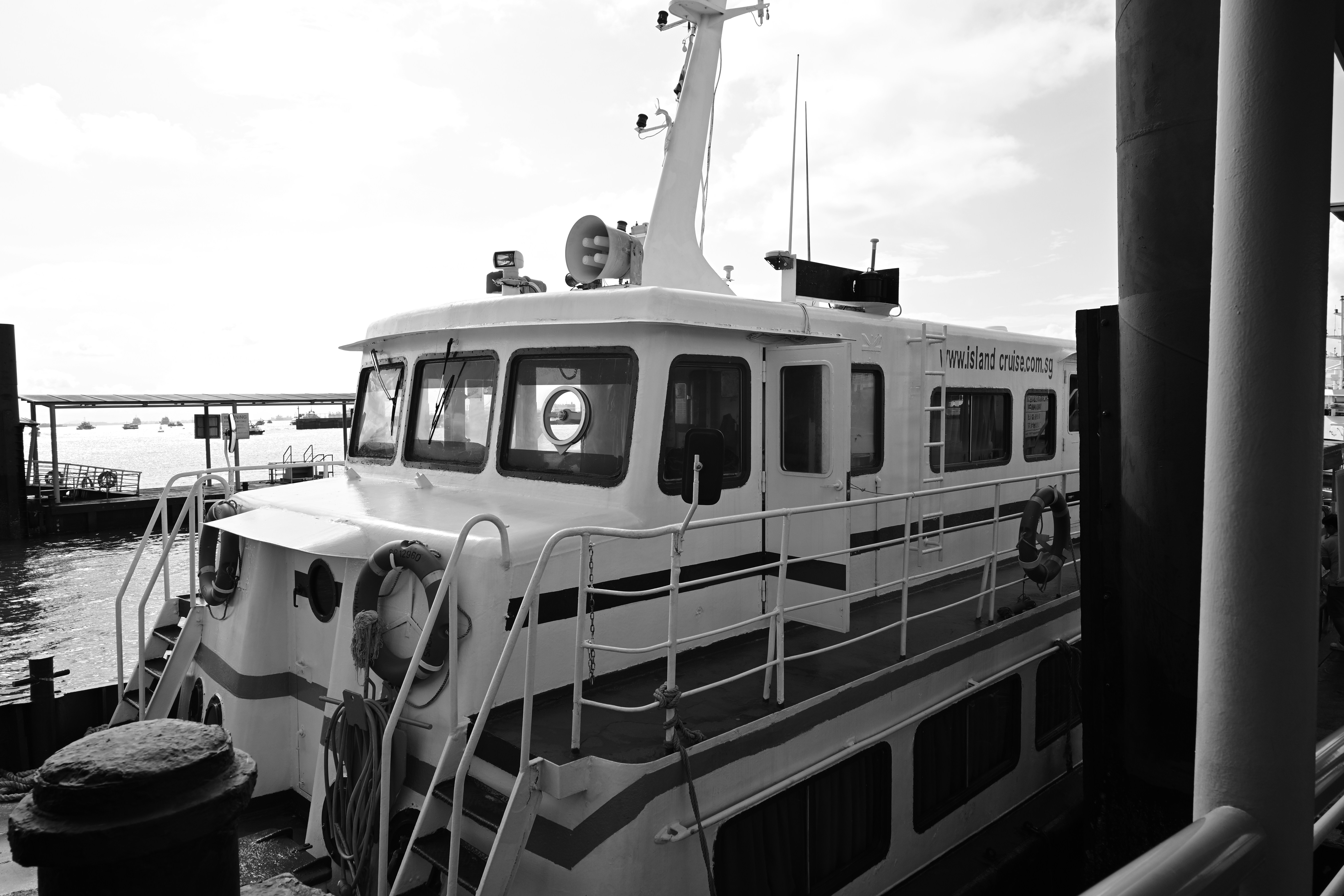 A ferry boat at the dock in black and white.