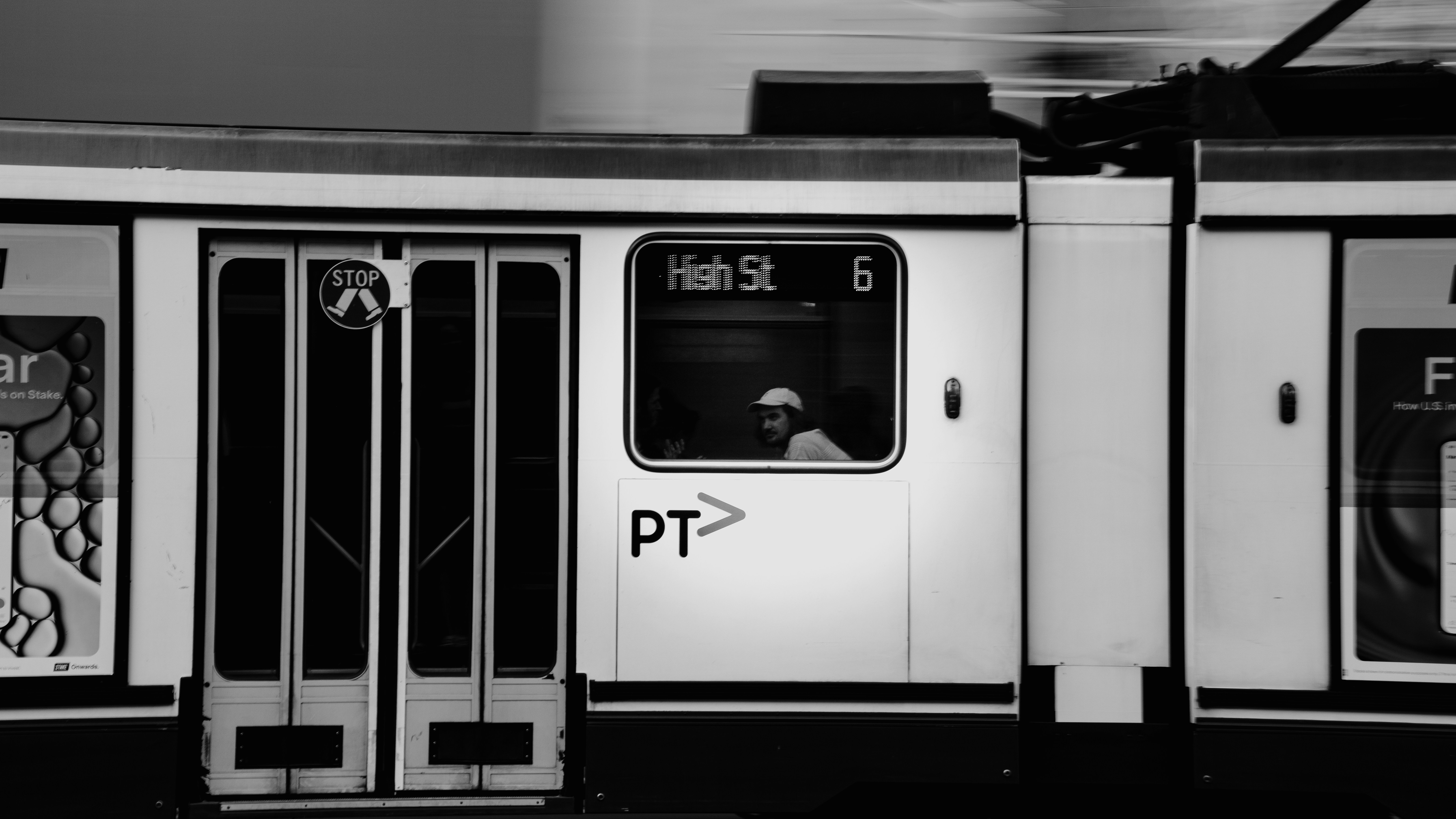 Black and white Melbourne tram at a stop