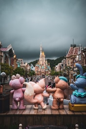 Disney characters pose in front of a castle.