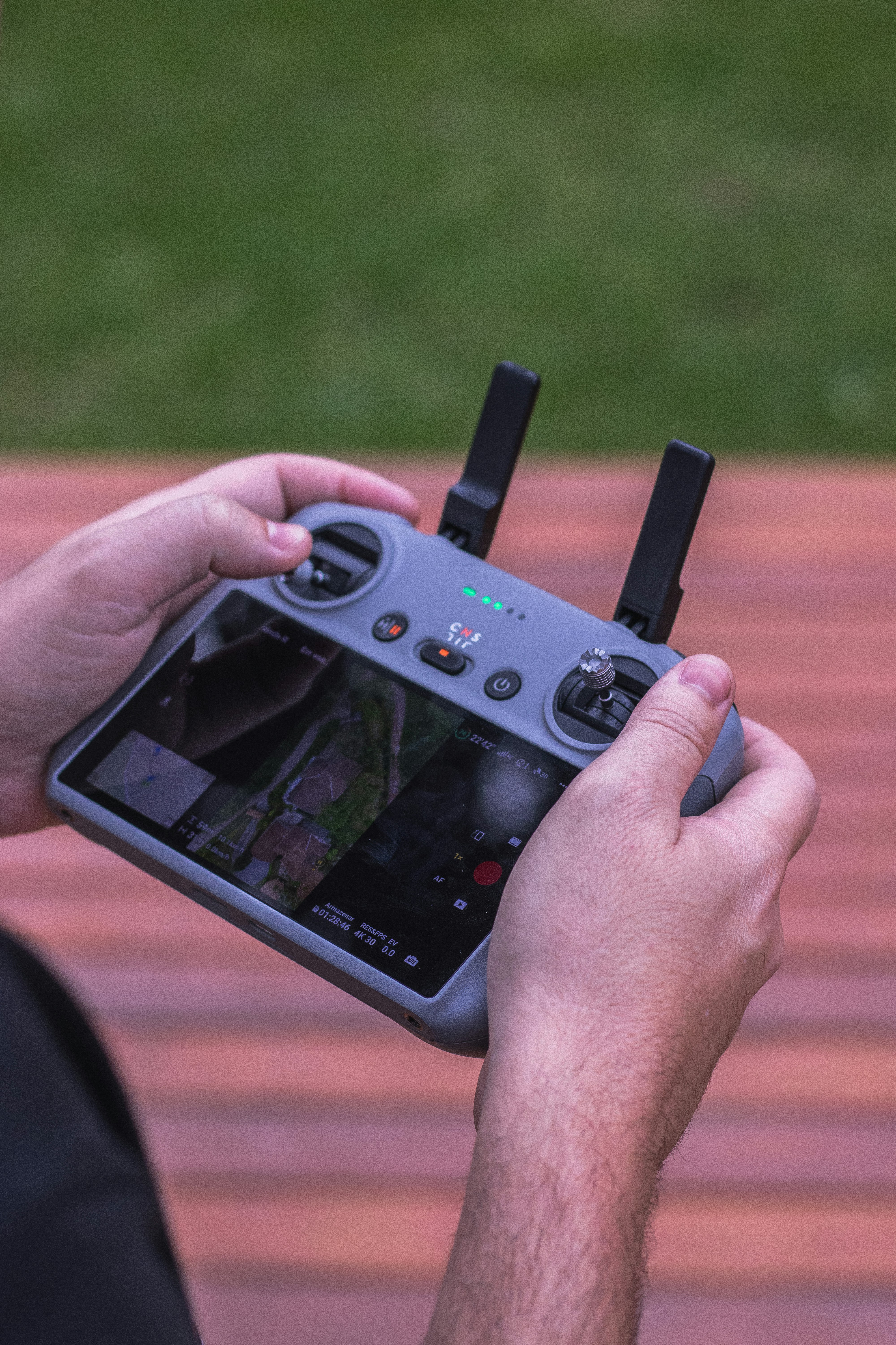 Person controls a drone with its remote controller.