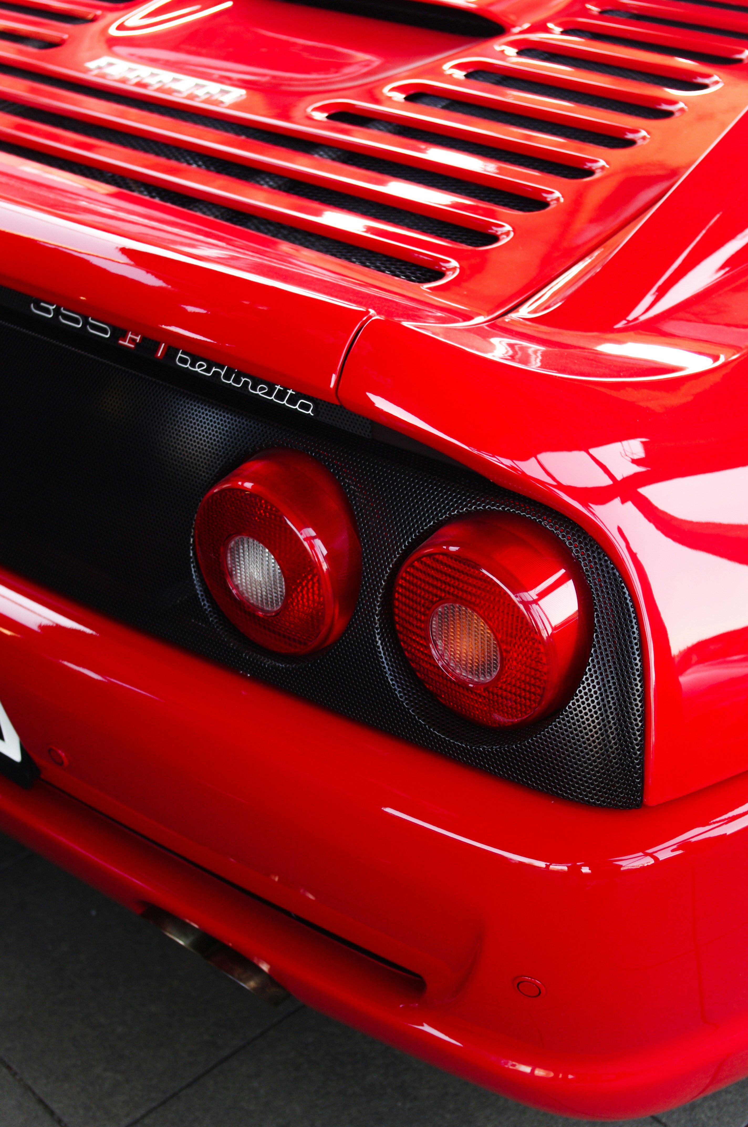 The red ferrari's tail lights are shiny. photo – Free Red Image on Unsplash