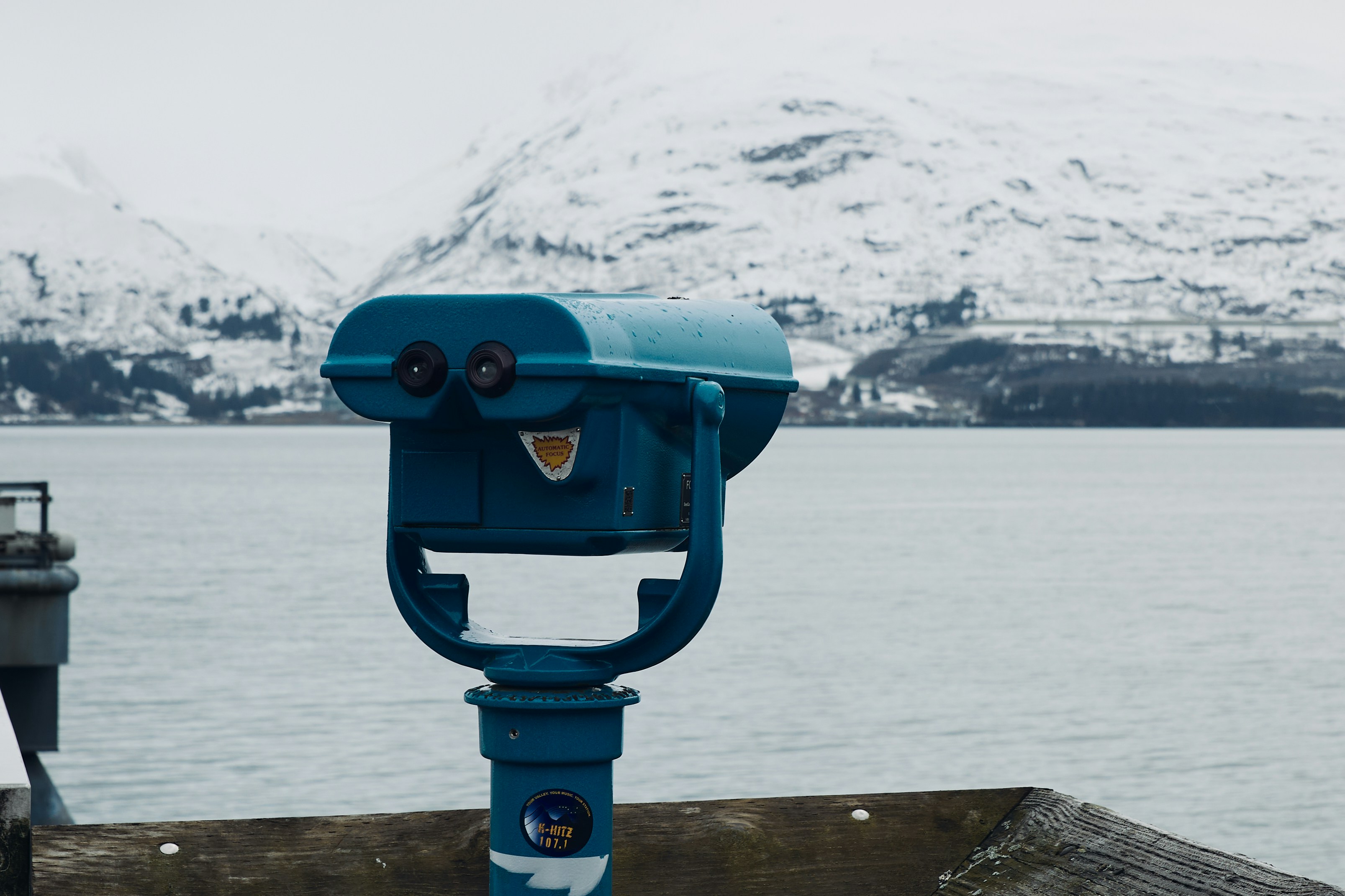 A blue viewer overlooks a snowy mountain landscape.