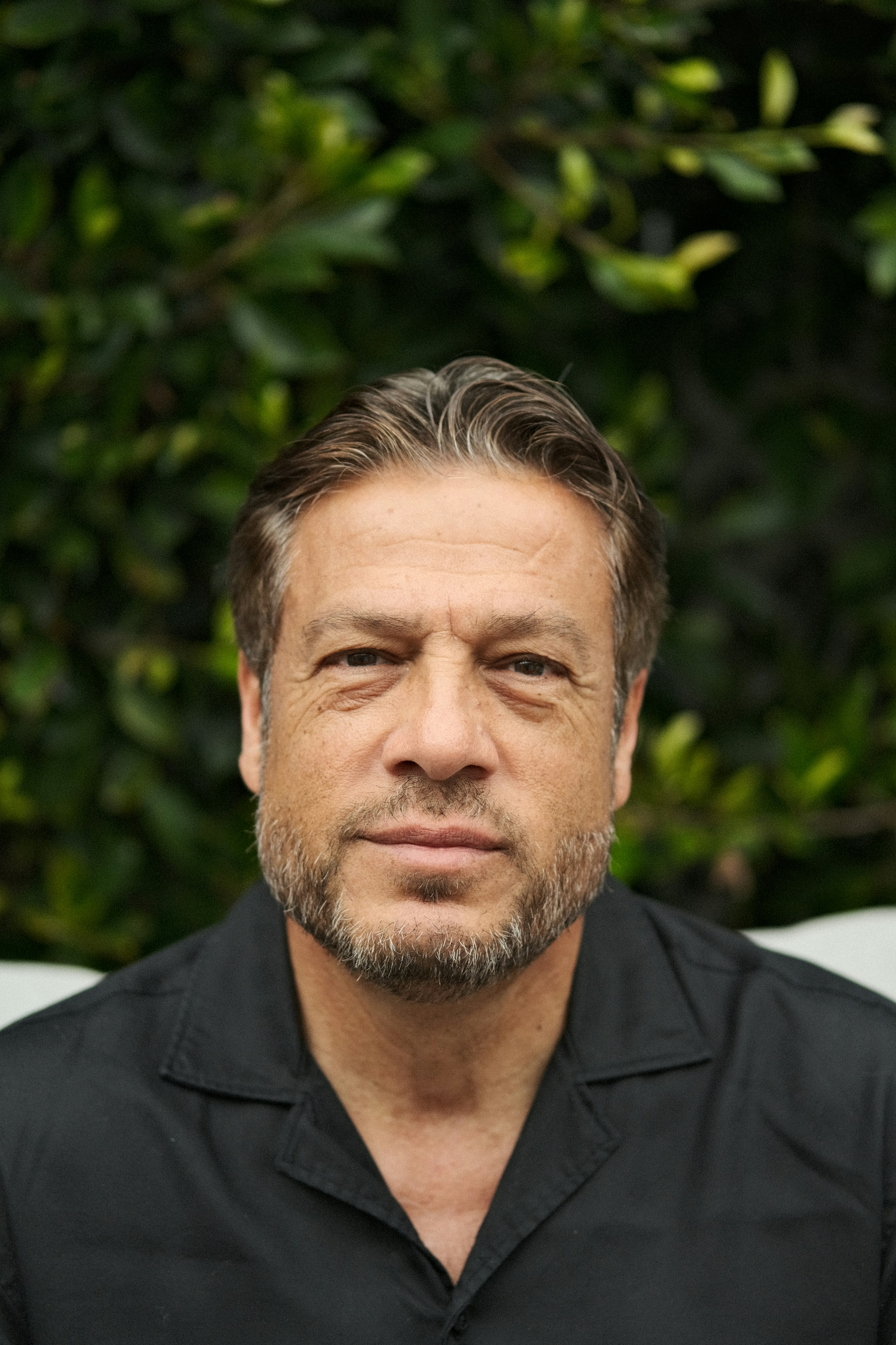 A middle-aged man is posing for a photo.