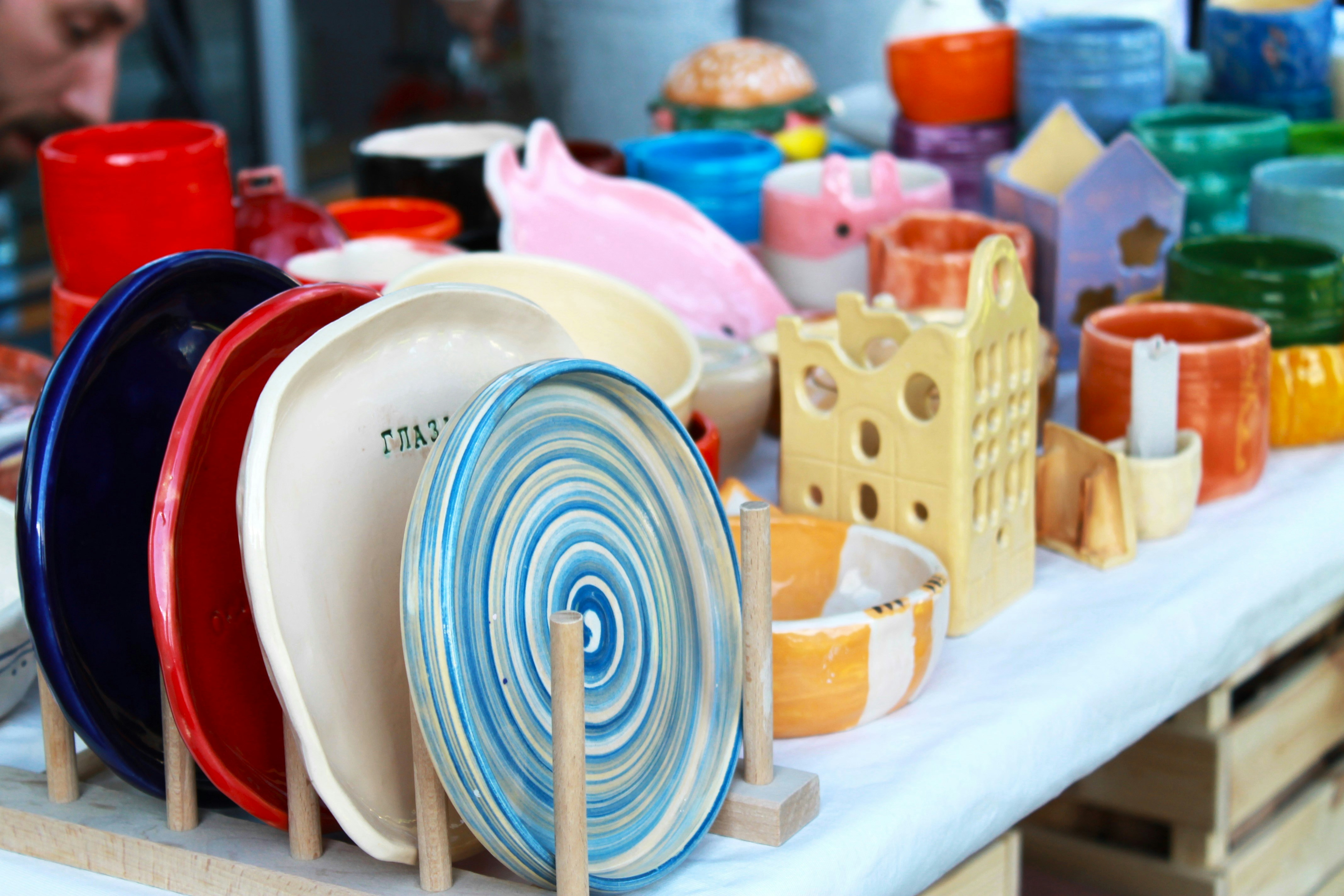 Various creative DIY projects made from everyday household items like painted rocks, yarn pom-poms, paper crafts, and repurposed containers, showcasing a vibrant collection of homemade art and decor.