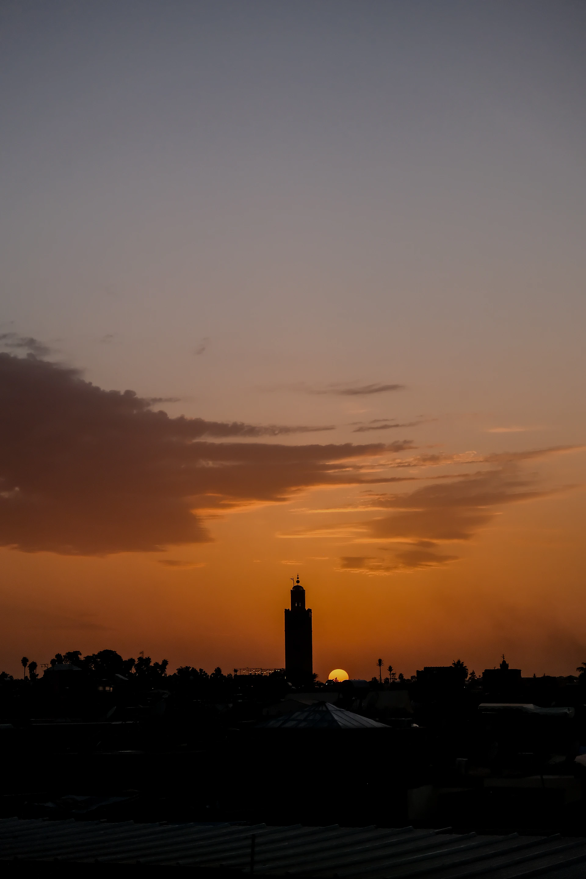 Sunset silhouette of a mosque and cityscape