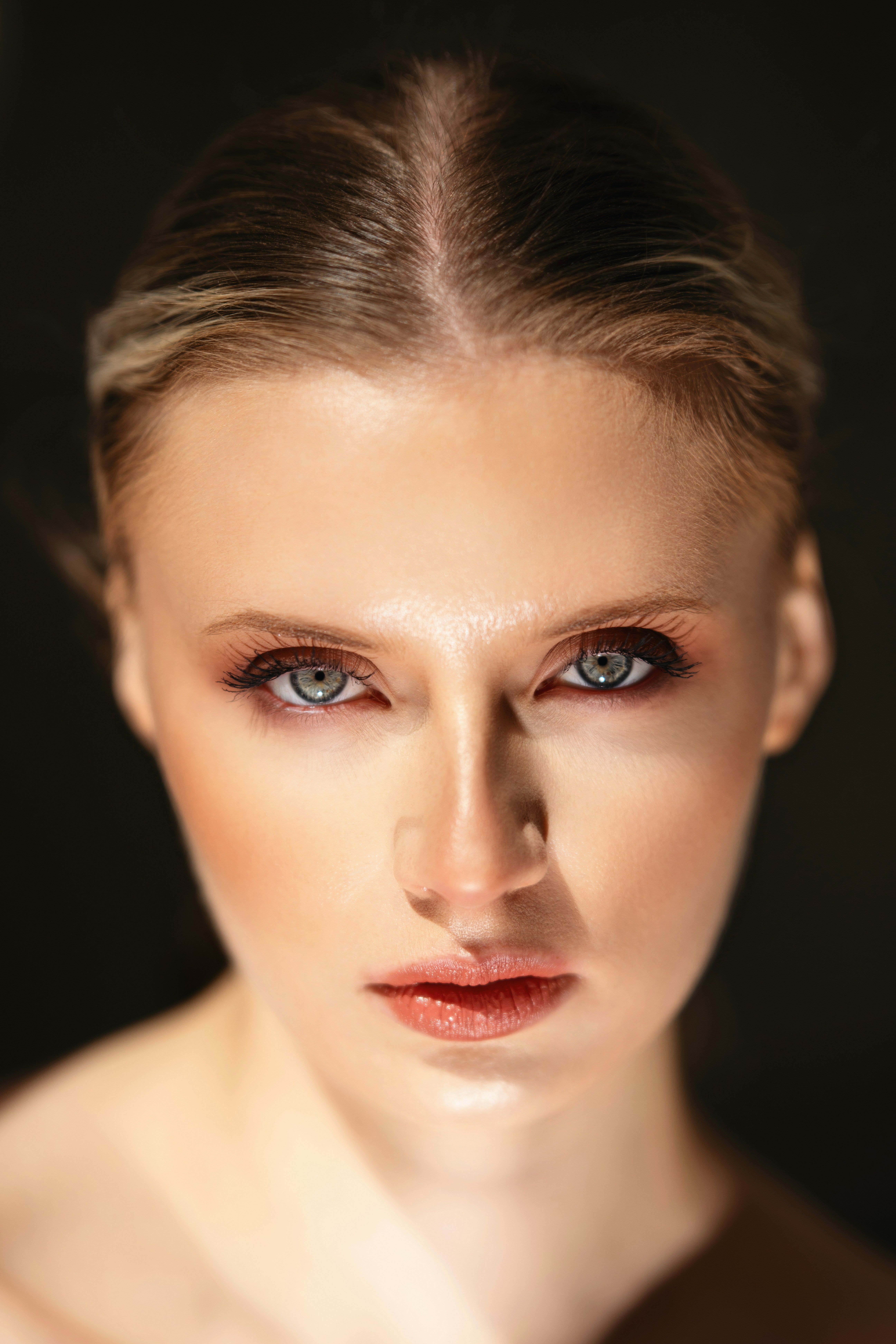 A woman with makeup poses for the camera.
