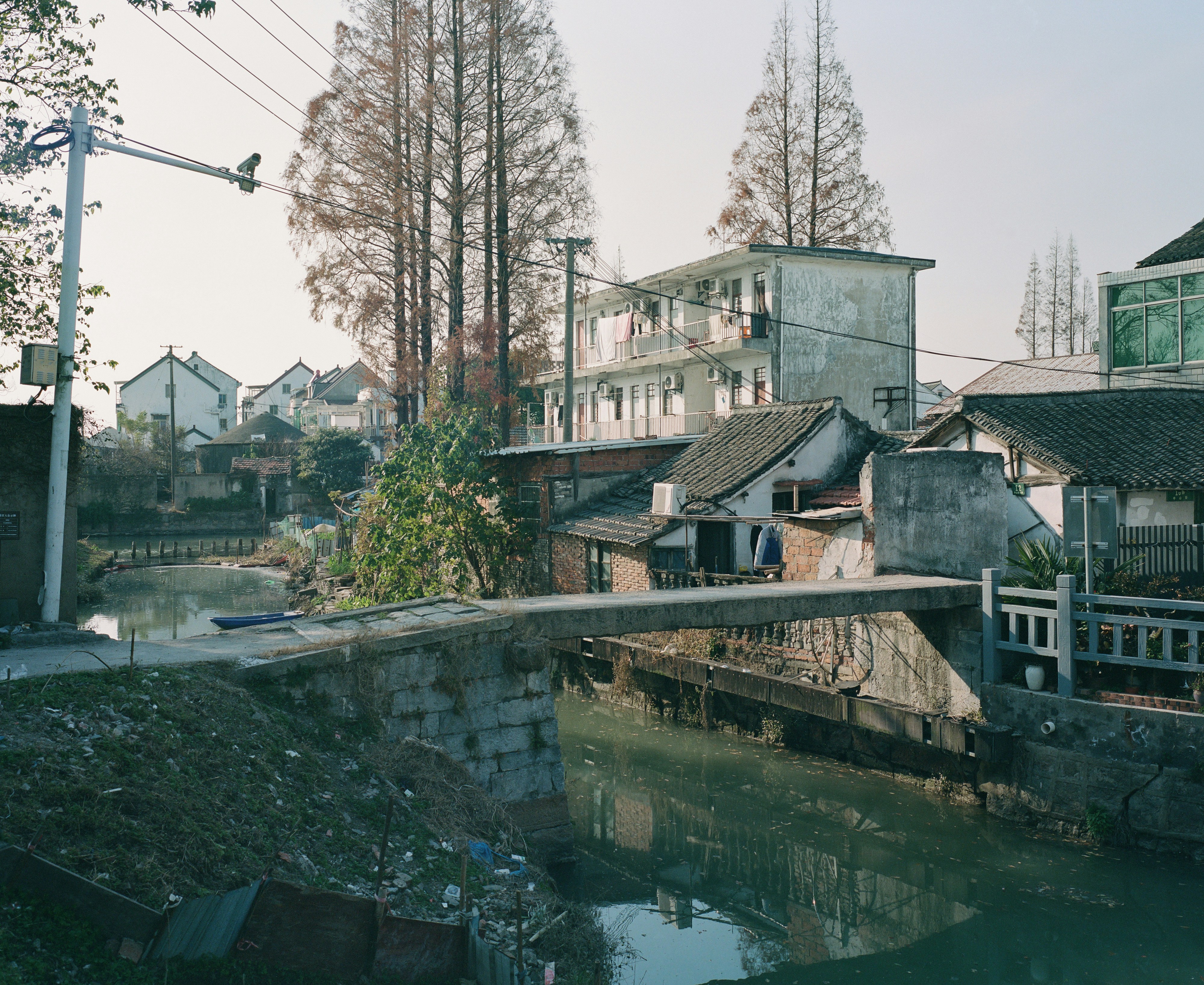 A bridge crosses a river in a small town.