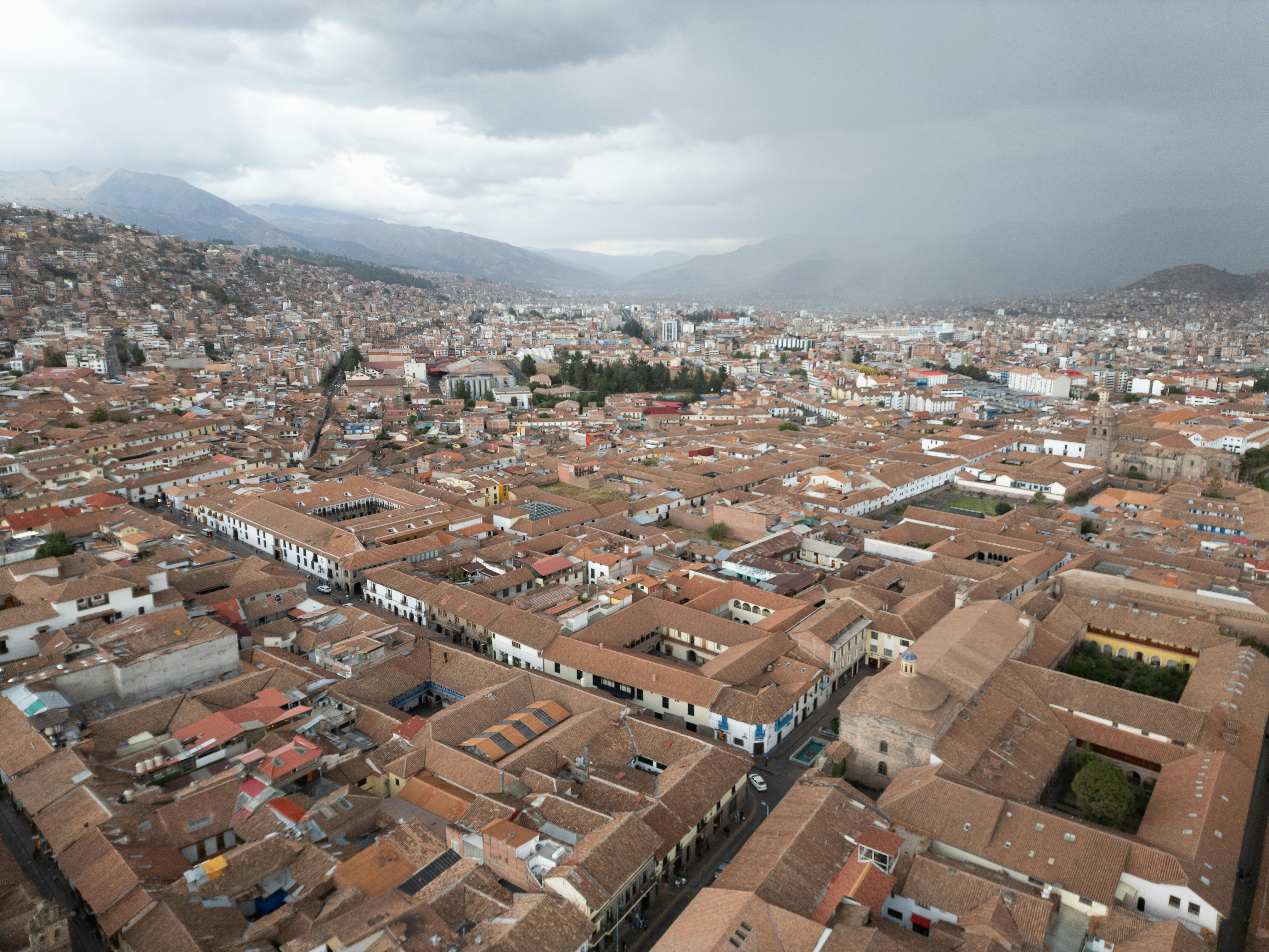Aerial view of a city with red rooftops.