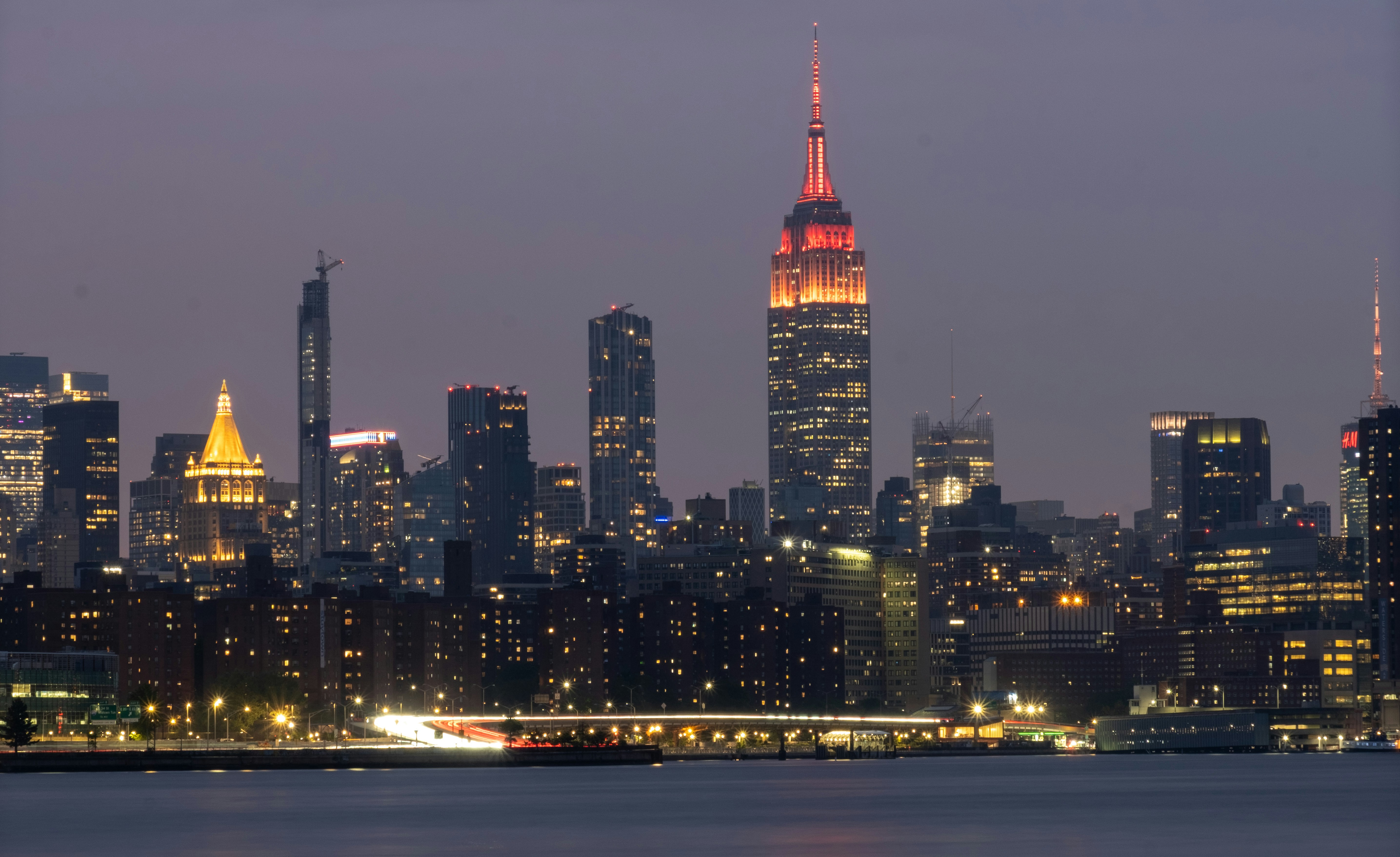 New york city skyline lights up at night.