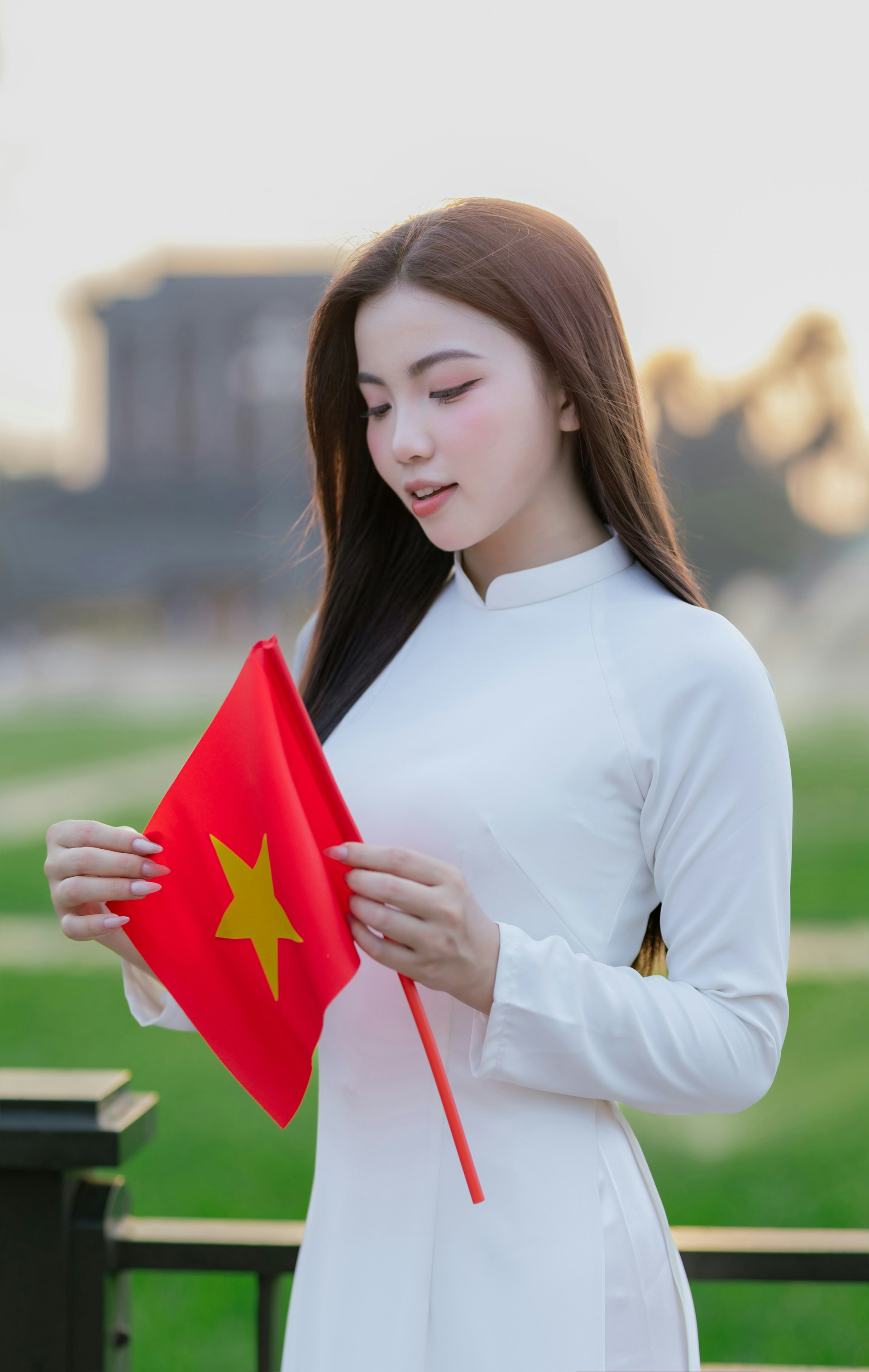 A woman holds the vietnamese flag.