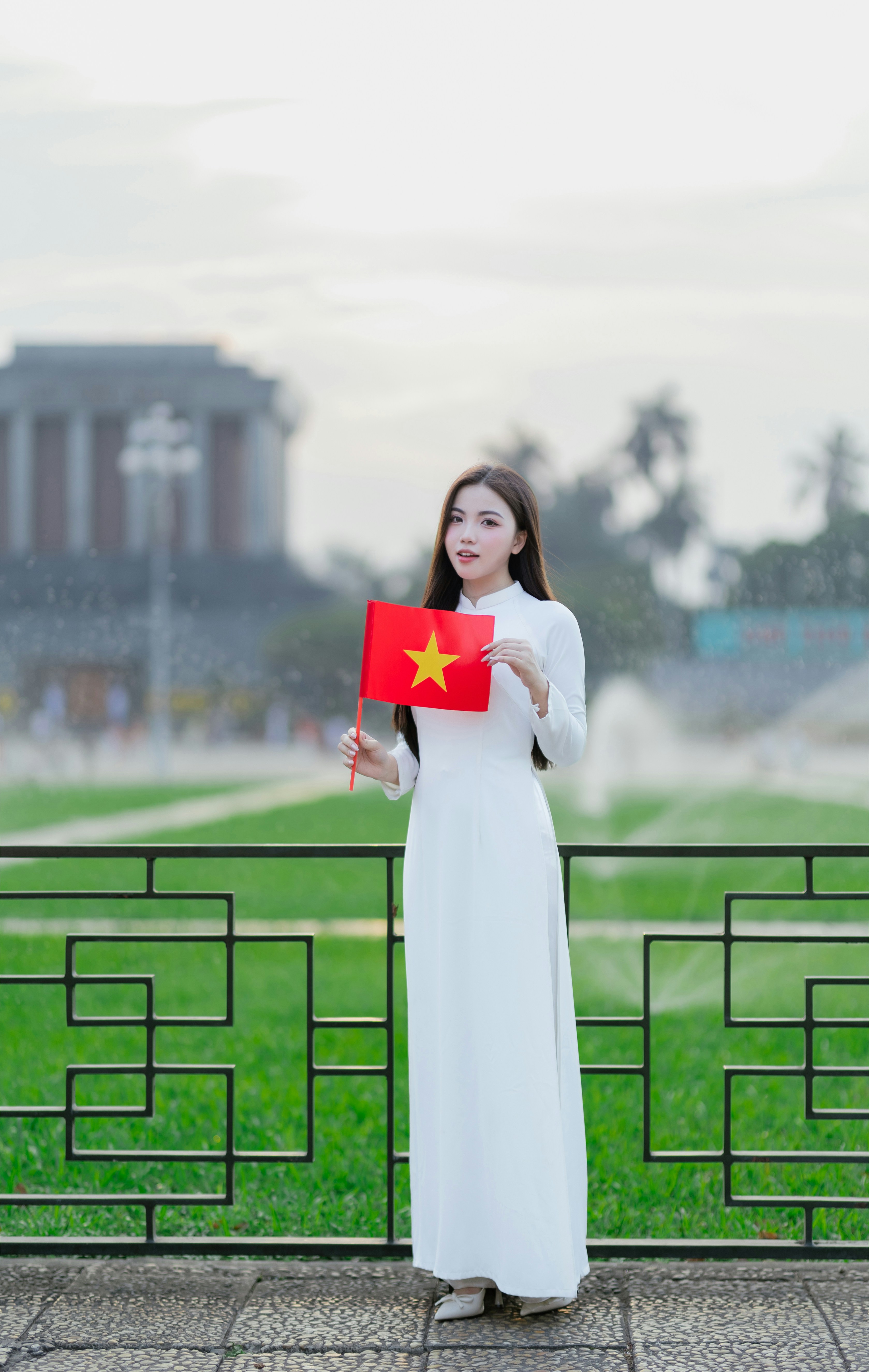 Woman in vietnam holds a flag.
