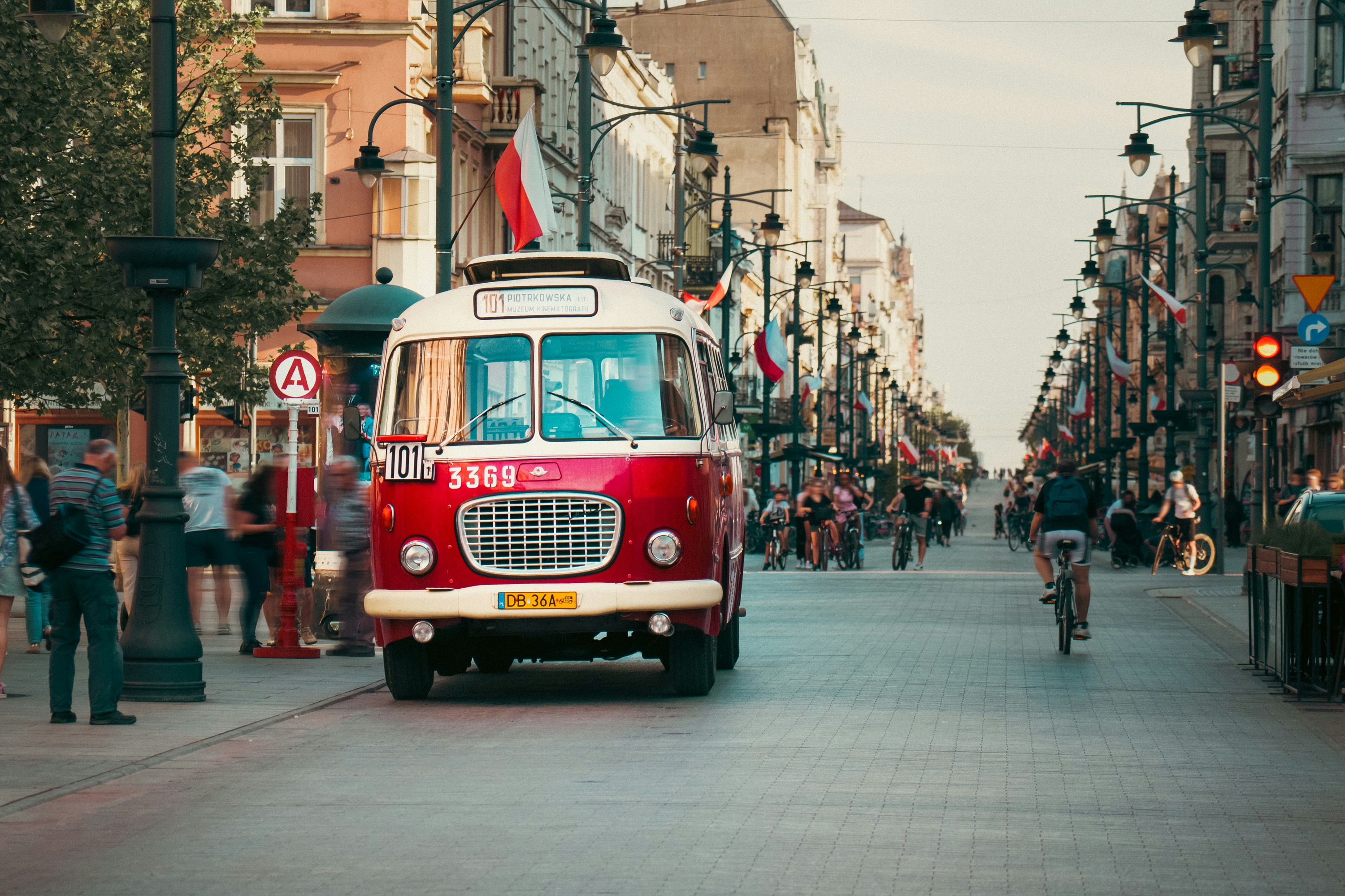 Historic red bus on a pedestrian town street in Lodz