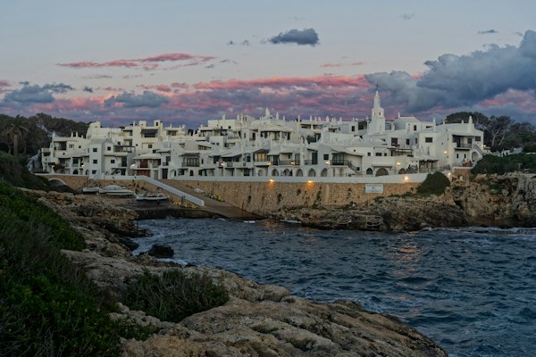 A white village on the shore at dusk — Menorca, Spain