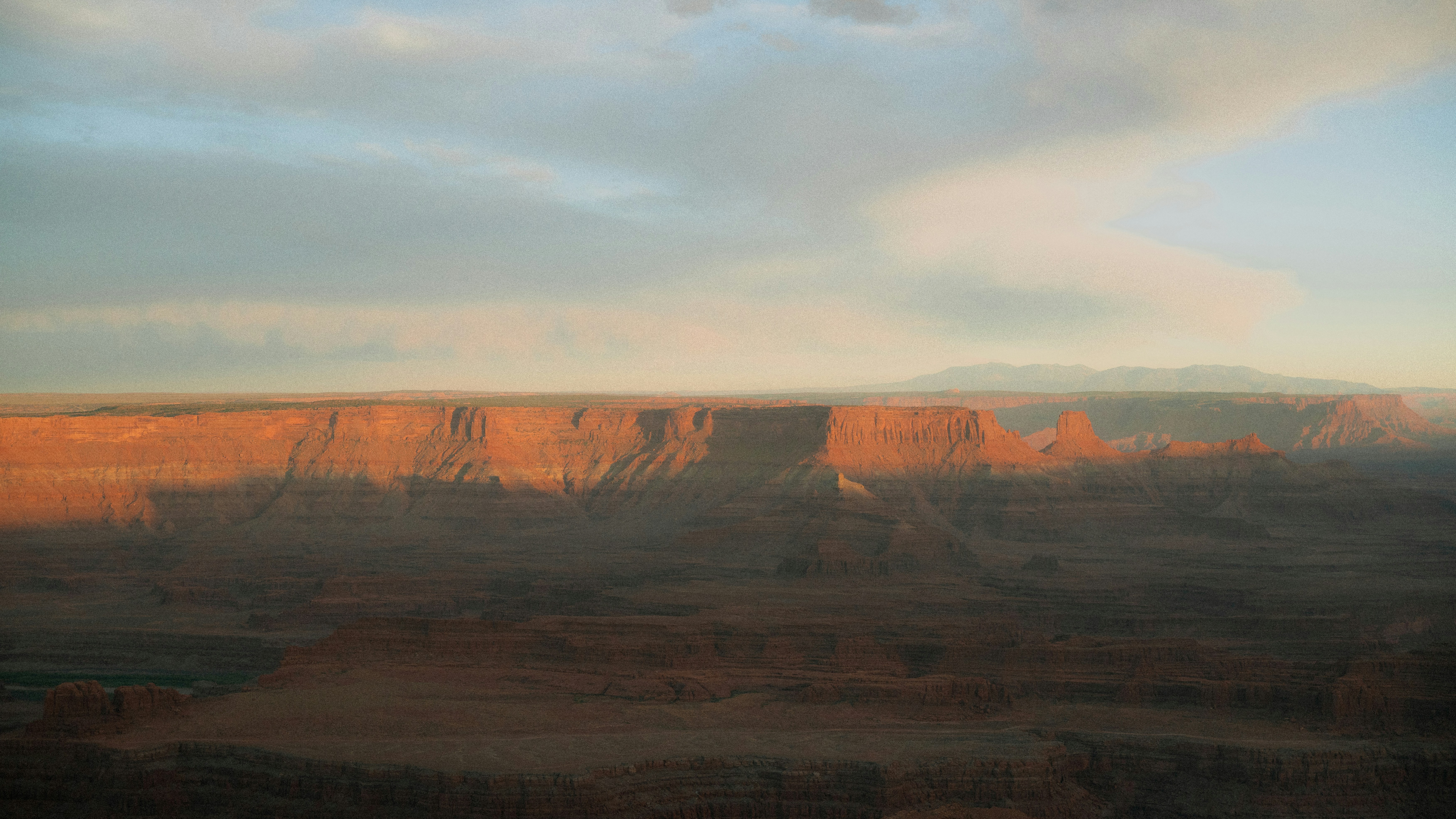 Sunrise illuminates a canyon landscape.