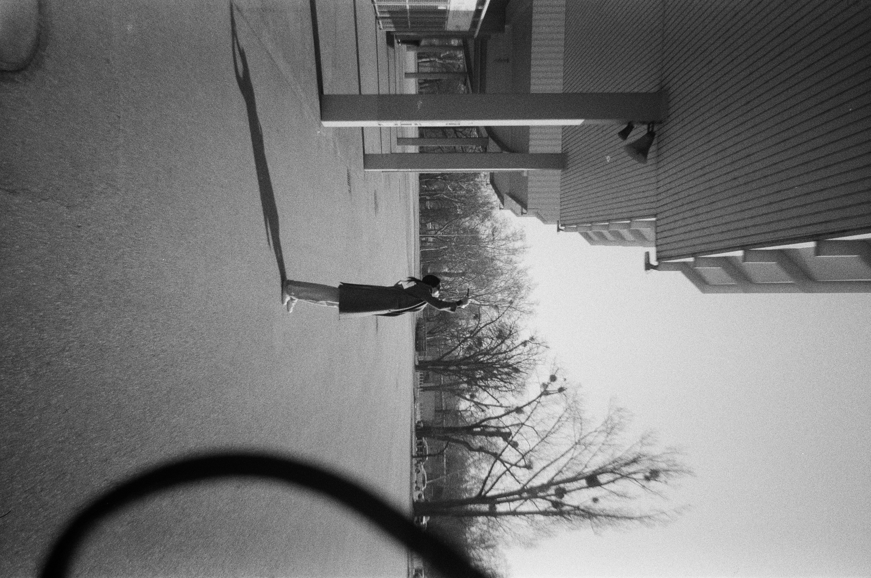 A person is walking outside on a sunny day.