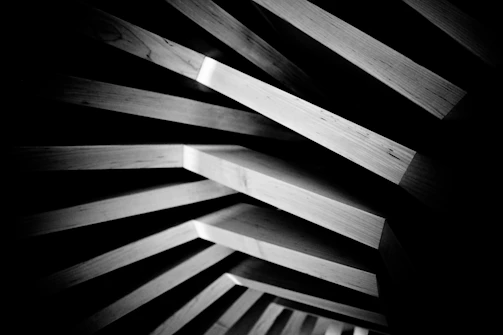 Wooden planks create geometric shapes and shadows.