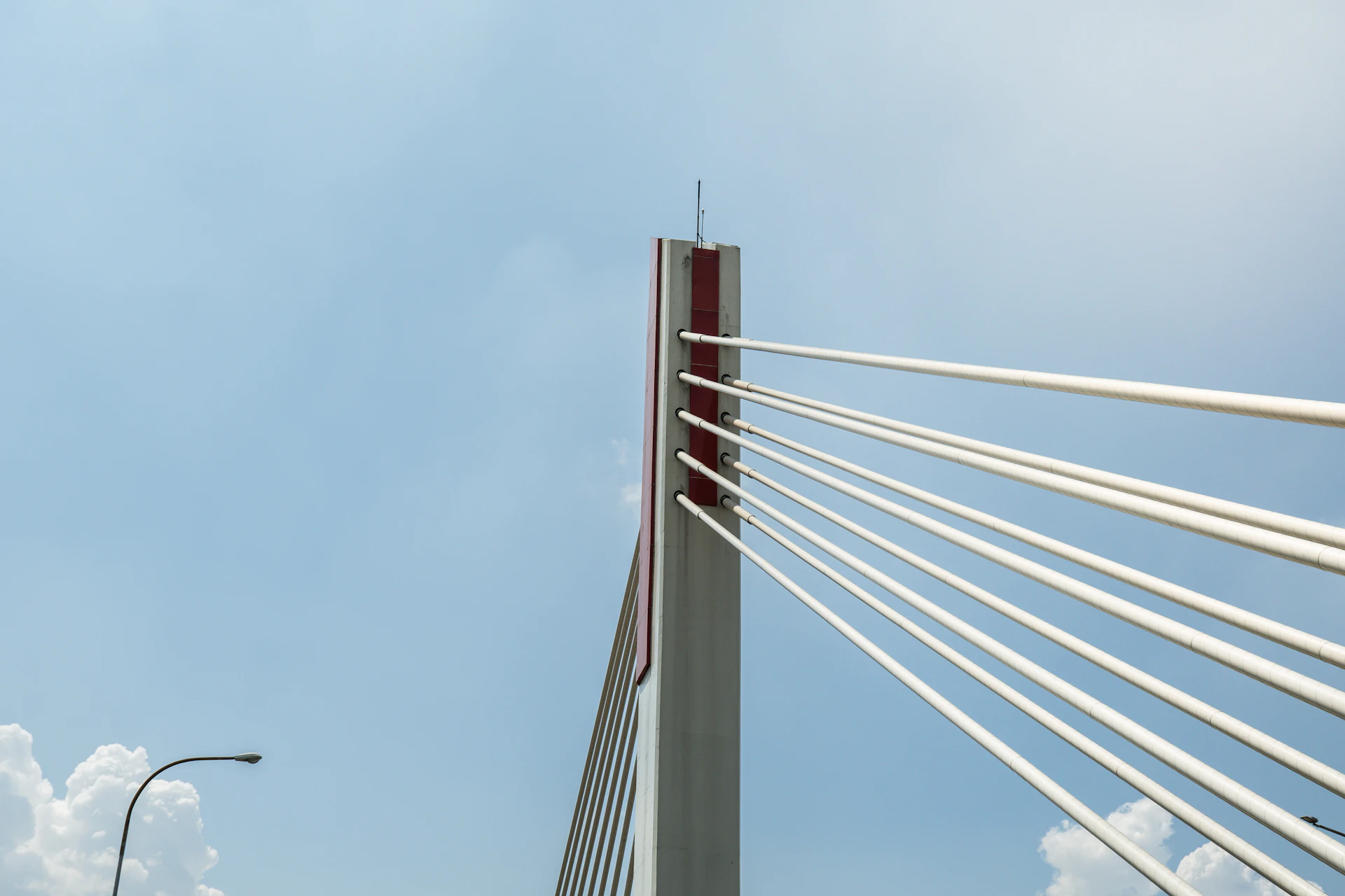Bridge tower with cables stretching into the sky.