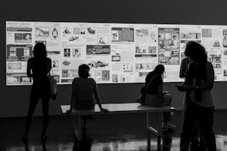 People admire an art display in a gallery.