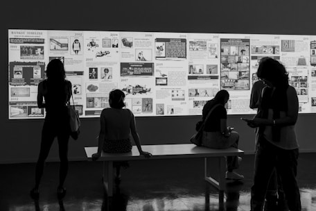 People admire an art display in a gallery.