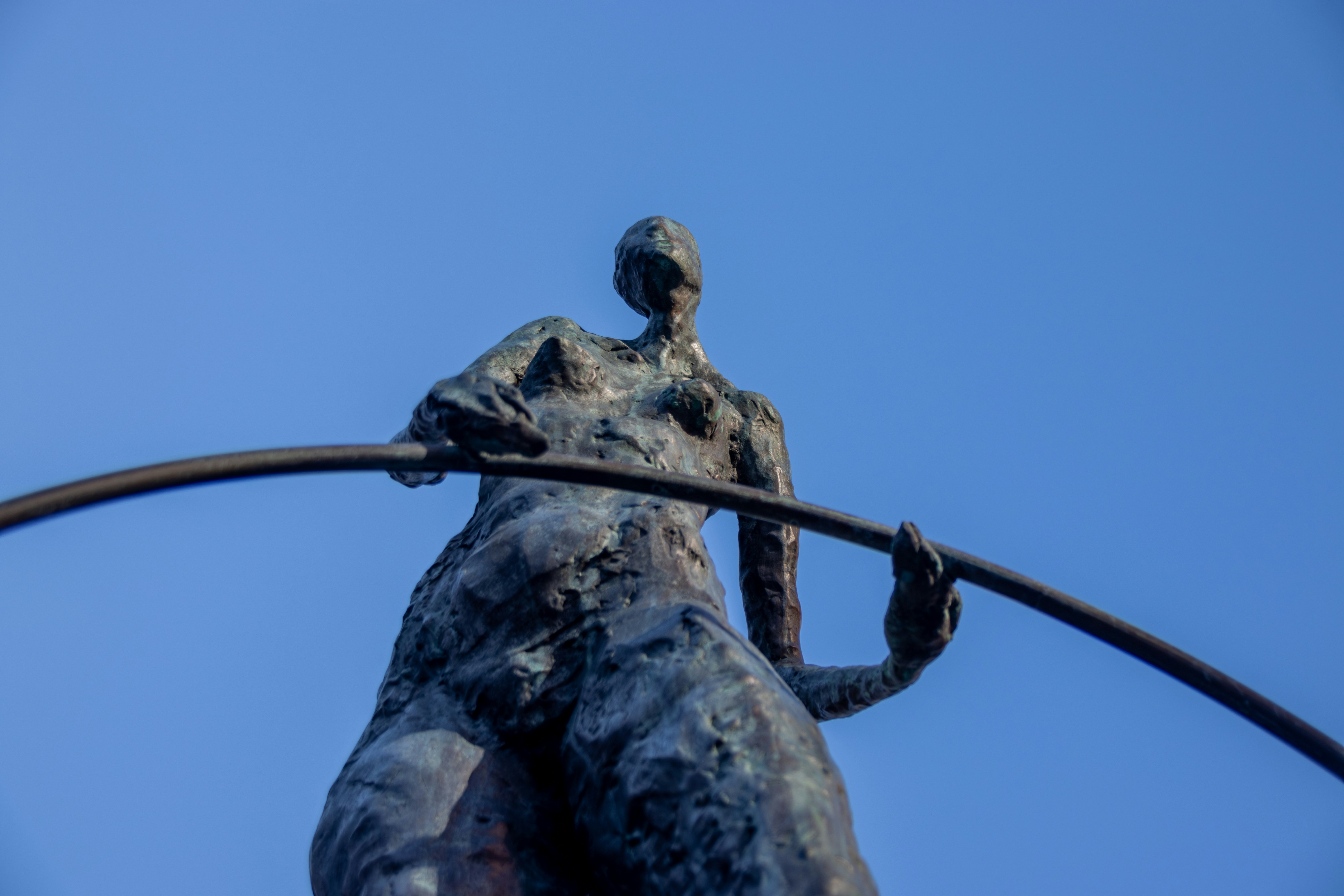 Statue of a person holding an arc.