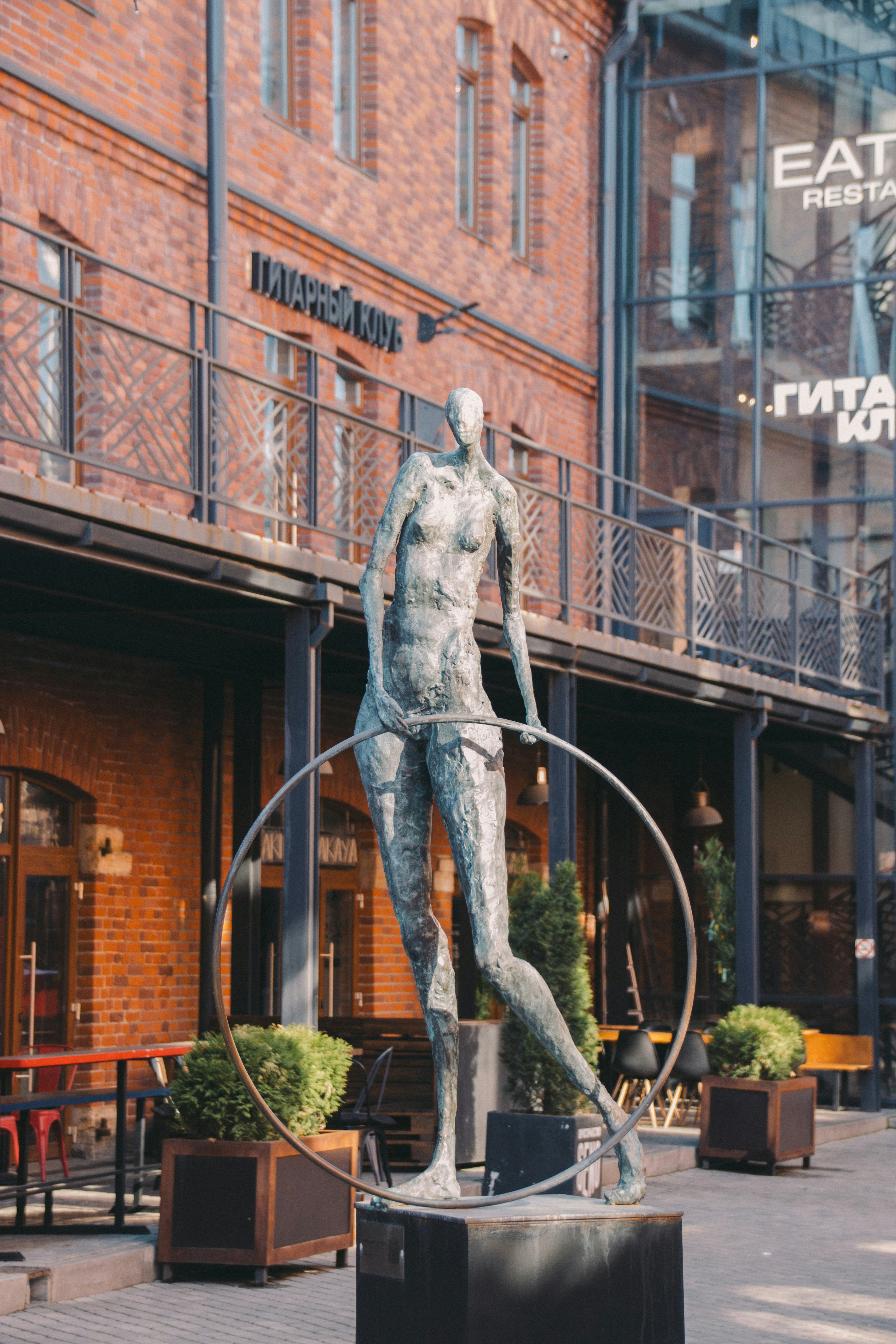 Statue of a woman with a hula hoop.