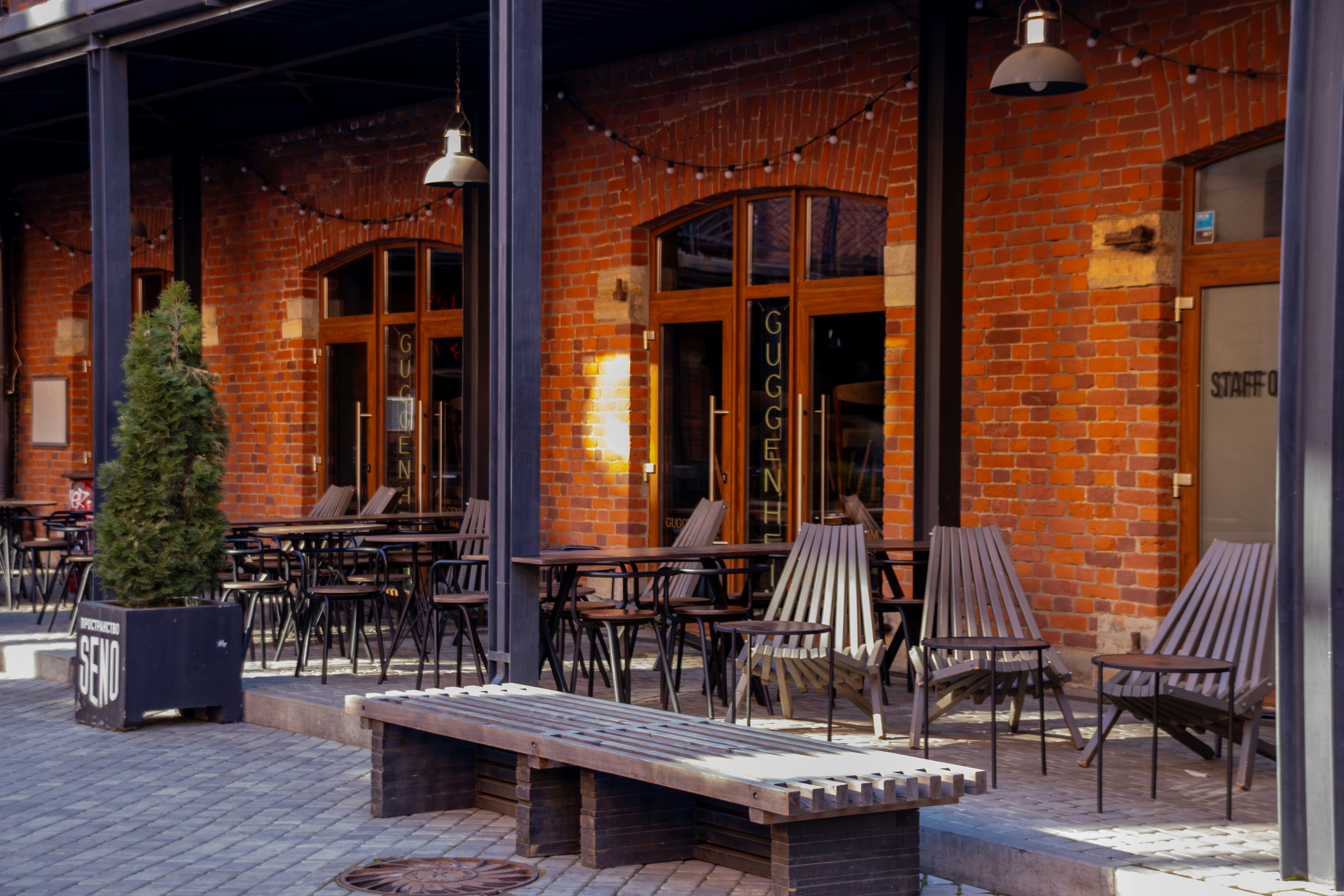 A red brick building with outdoor seating.