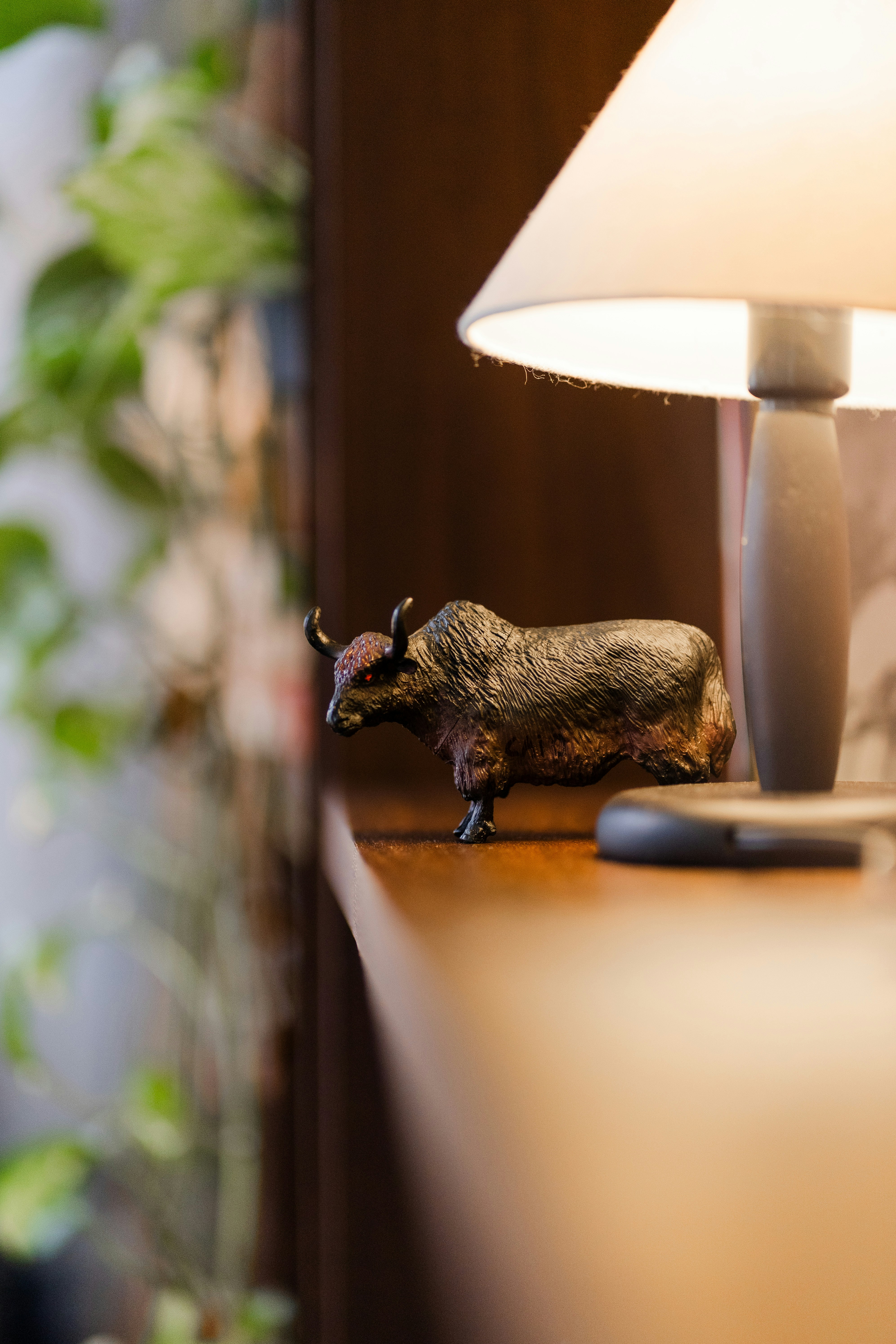 A miniature ox figurine next to a lamp. photo – Free Animal Image on ...