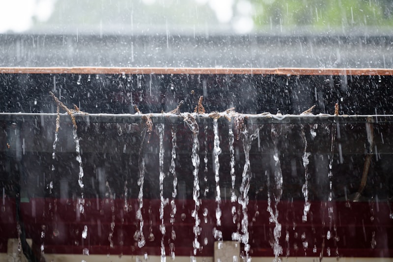 Rainwater flowing from a roof gutter